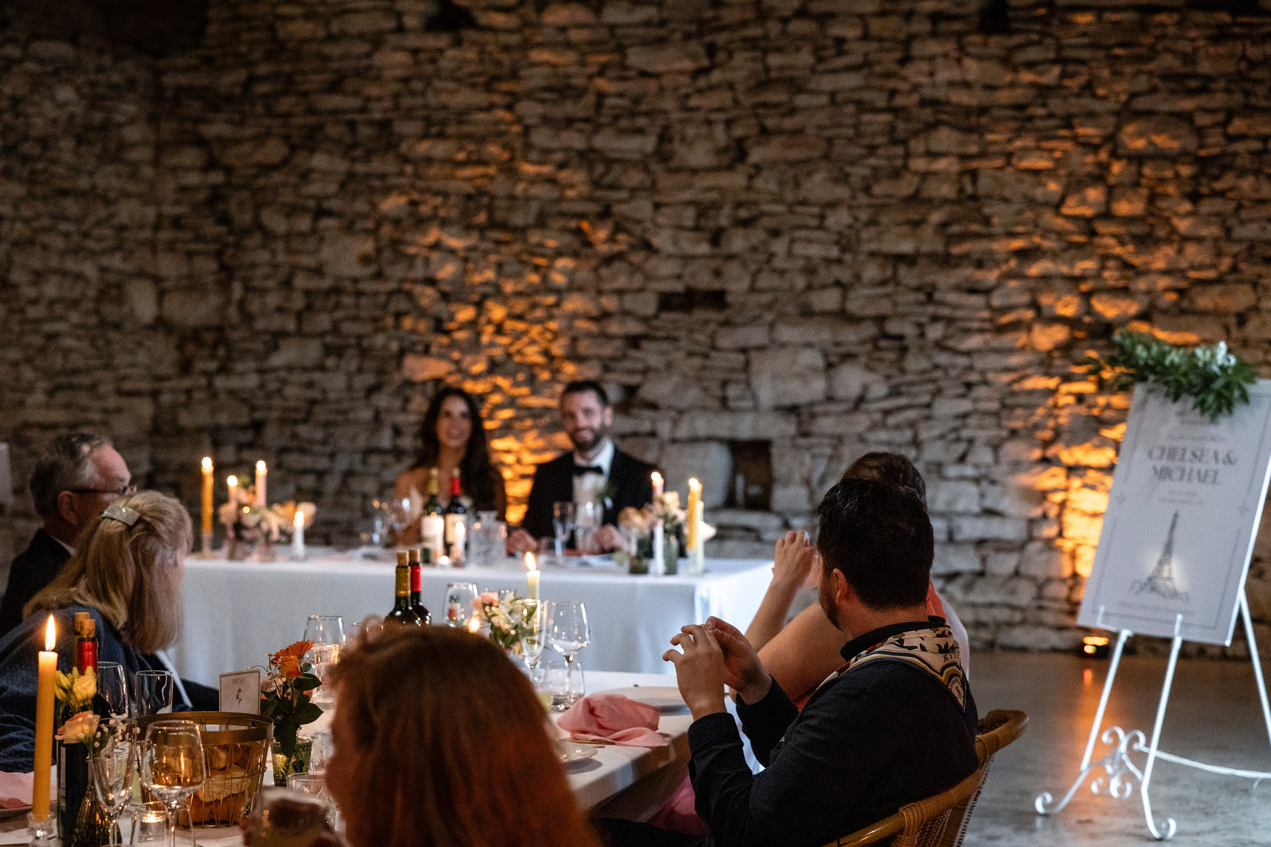 Candlelit wedding dinner indoors at Château Lagut, Dordogne France.