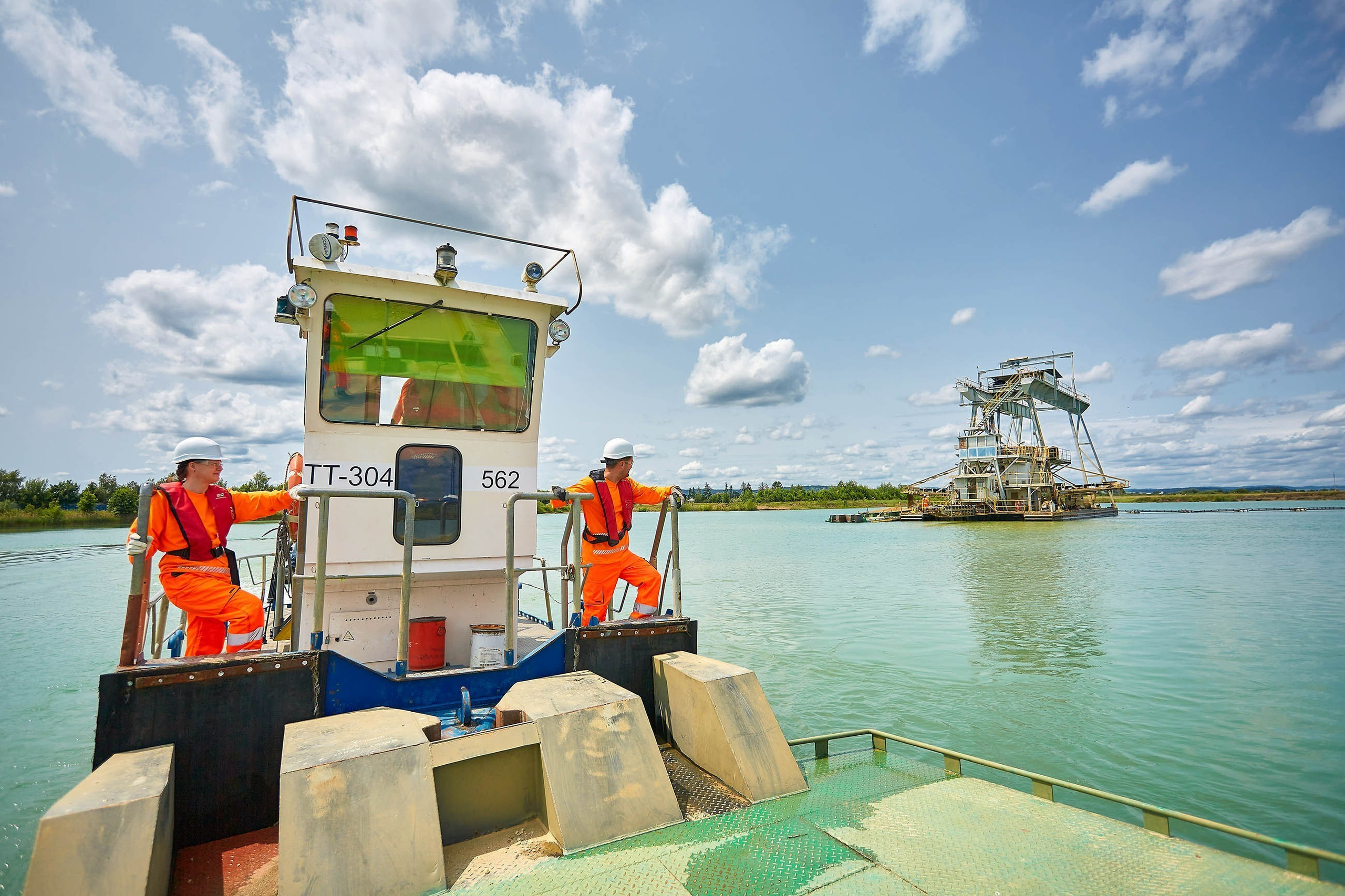 CEMEX workers on barge during dredging, Czech Republic.
