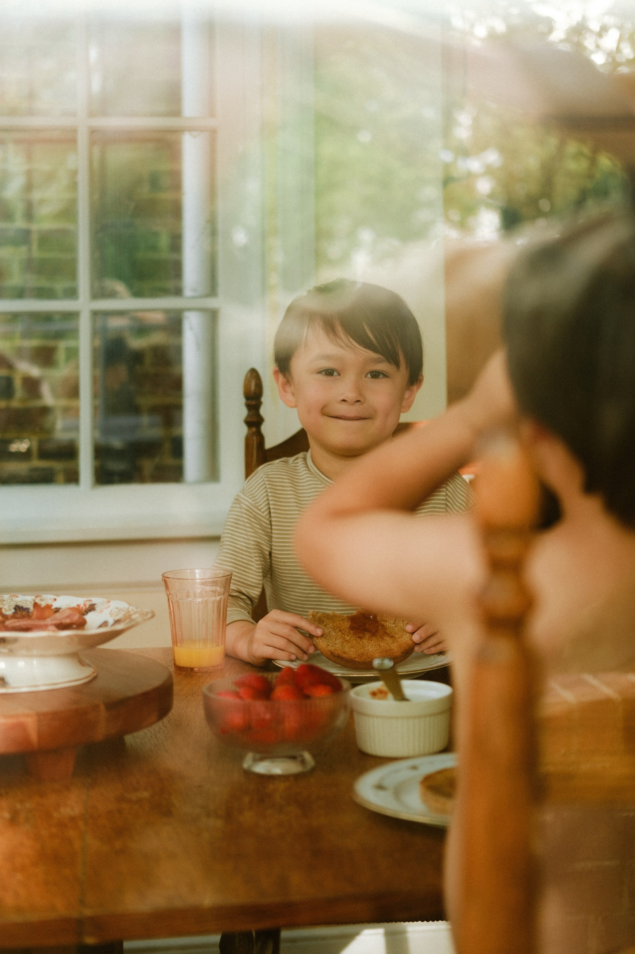 Boy's portrait taking through the glass in a beautiful Victorian style house in Richmond, VA