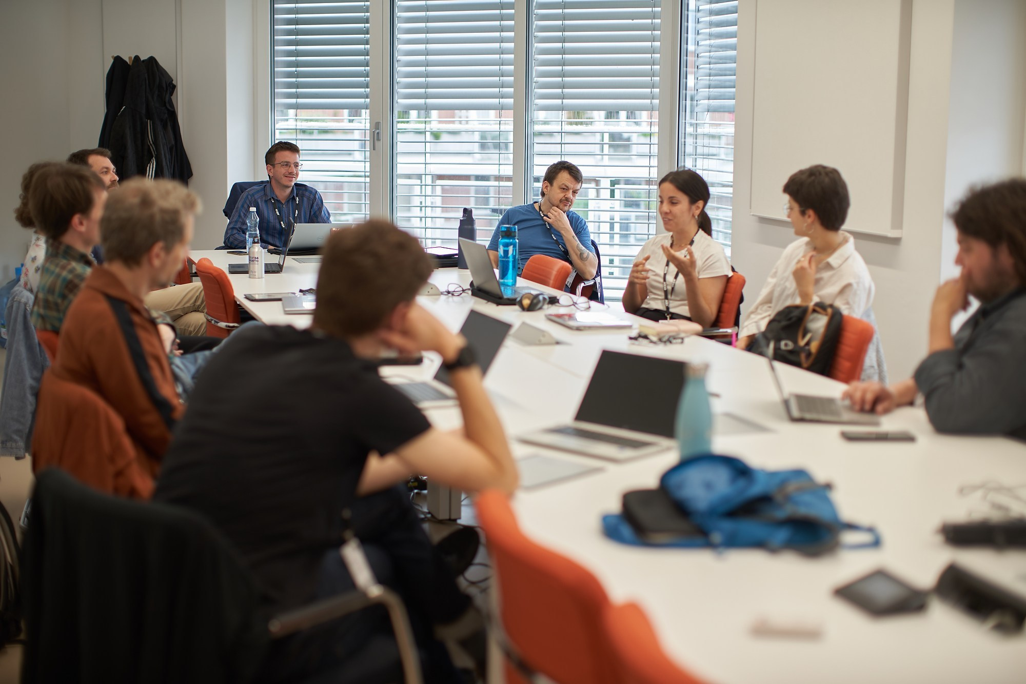 A small group of researchers collaborates around a table in an interactive ECPR workshop session.