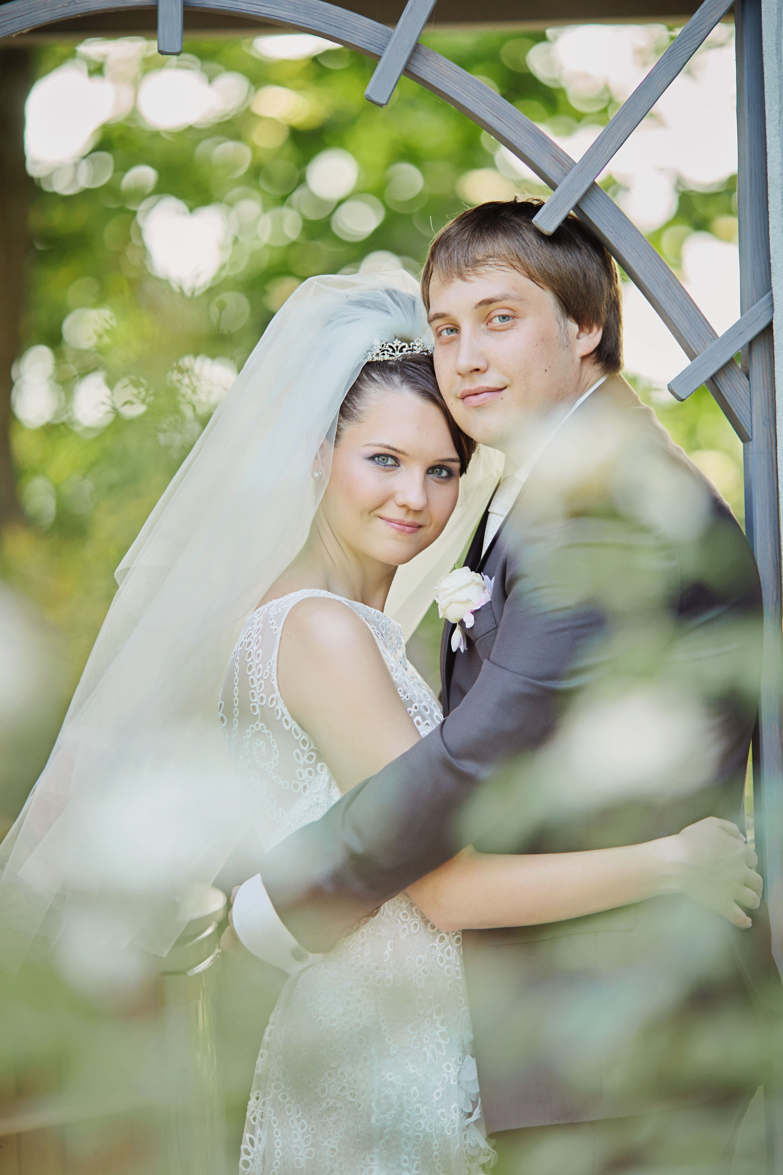 Chateau Mcely's floral gardens set the stage for a loving embrace between the bride and groom on their nuptials.