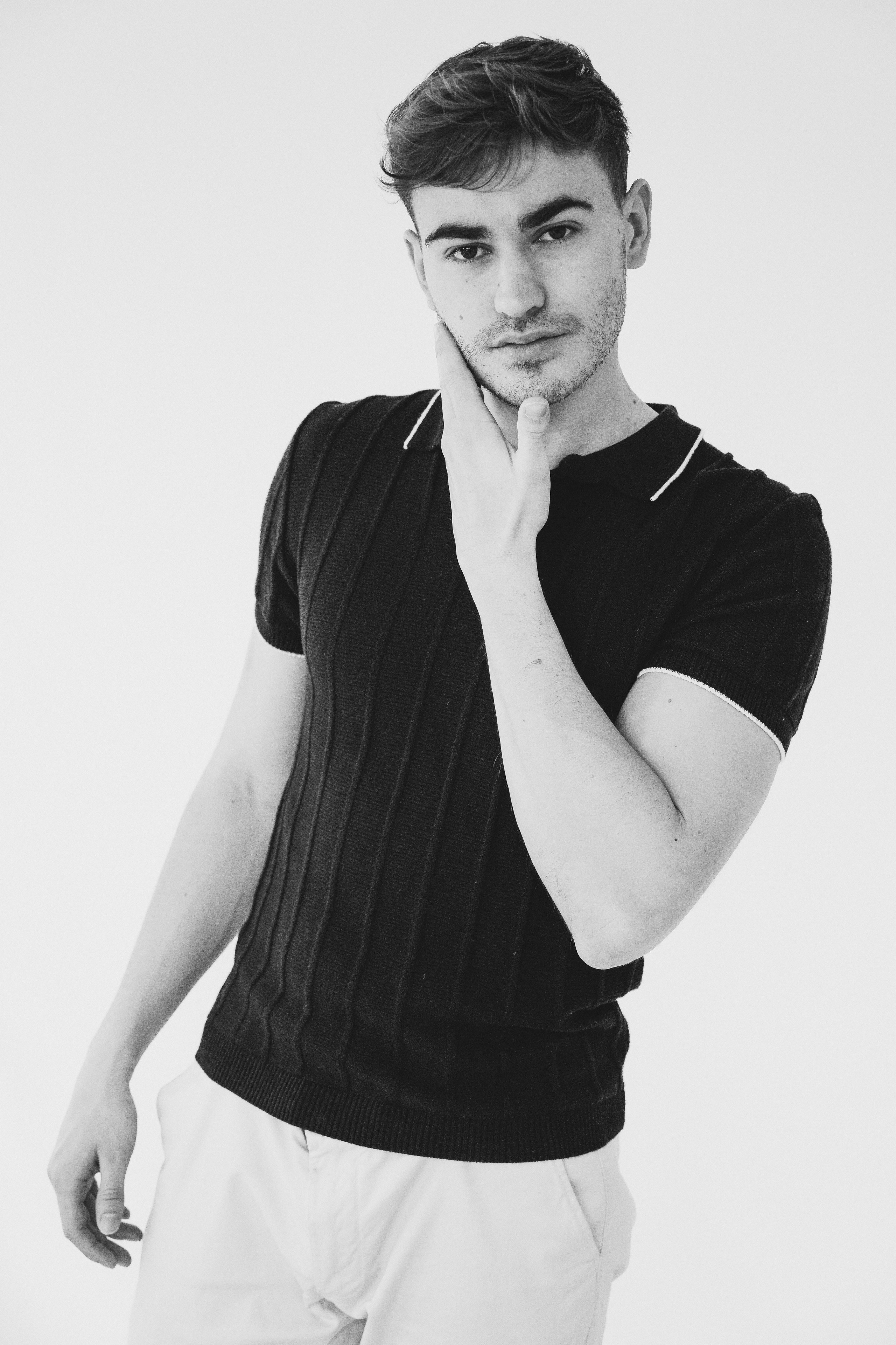 Male model in casual black outfit, styled for clean, lifestyle modeling portfolio.