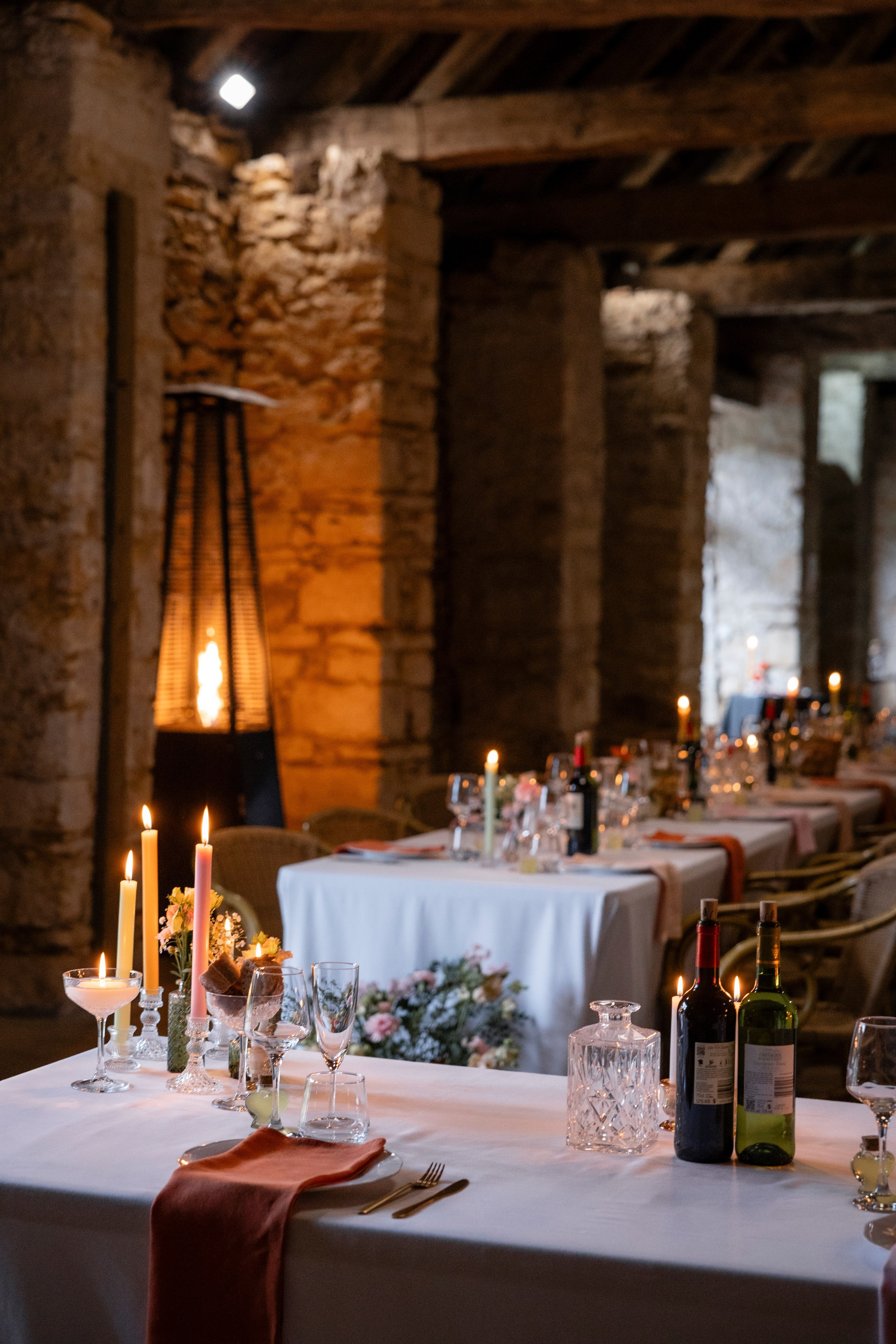 Candlelit wedding dinner indoors at Château Lagut, Dordogne France.