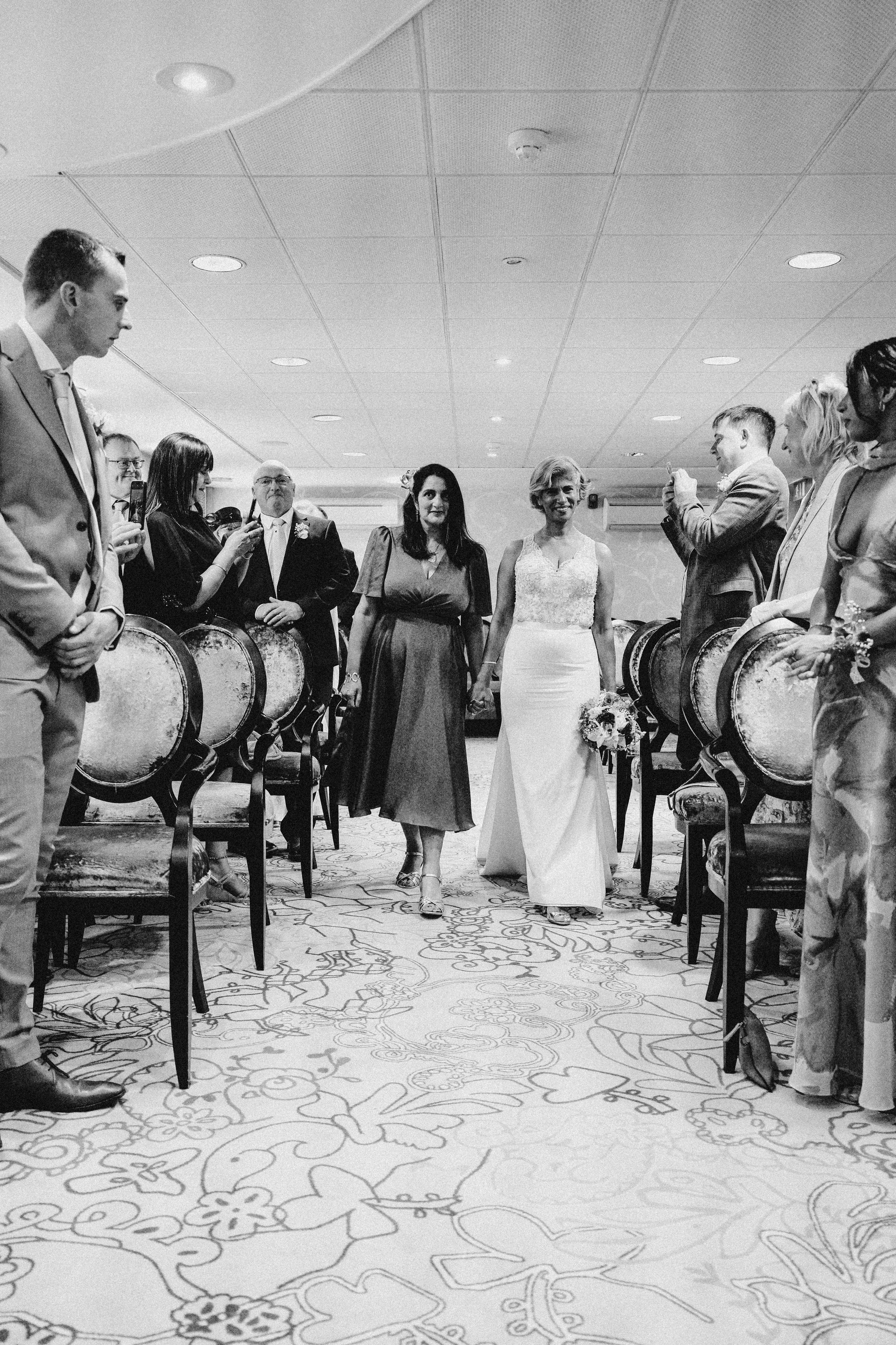 Best friends embracing the bride during the evening celebration