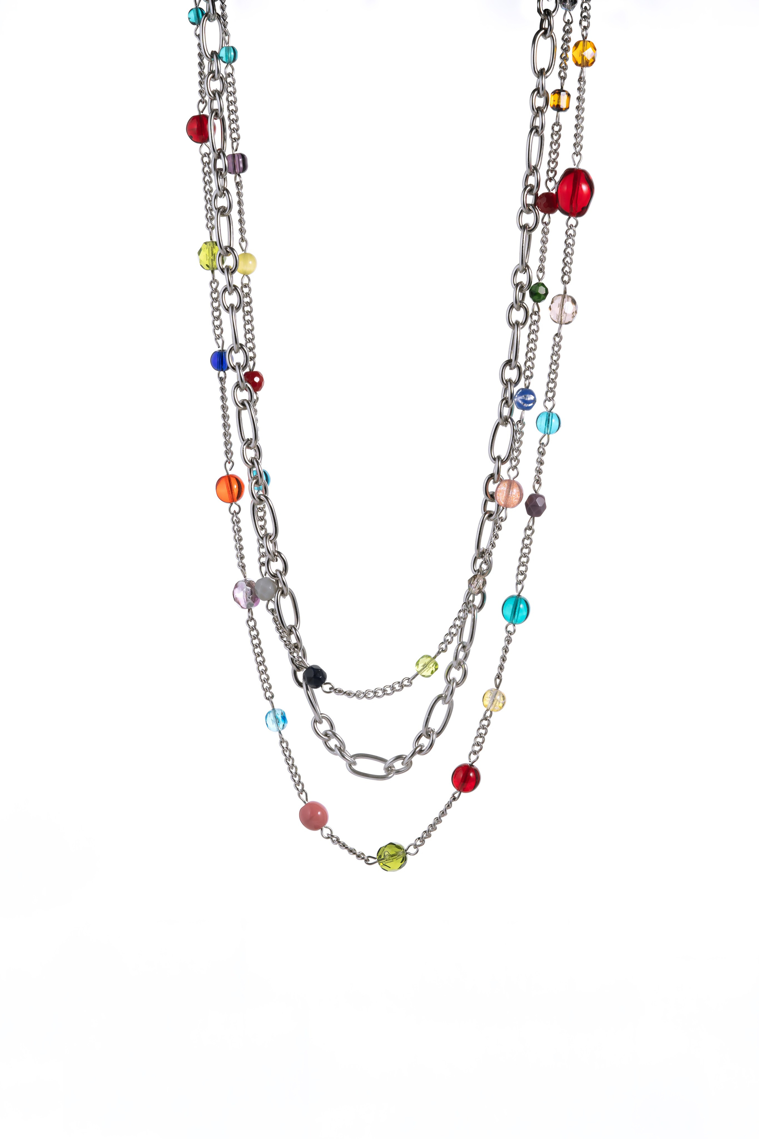 Photograph of a jewelry set in a black background, focusing on intricate designs.