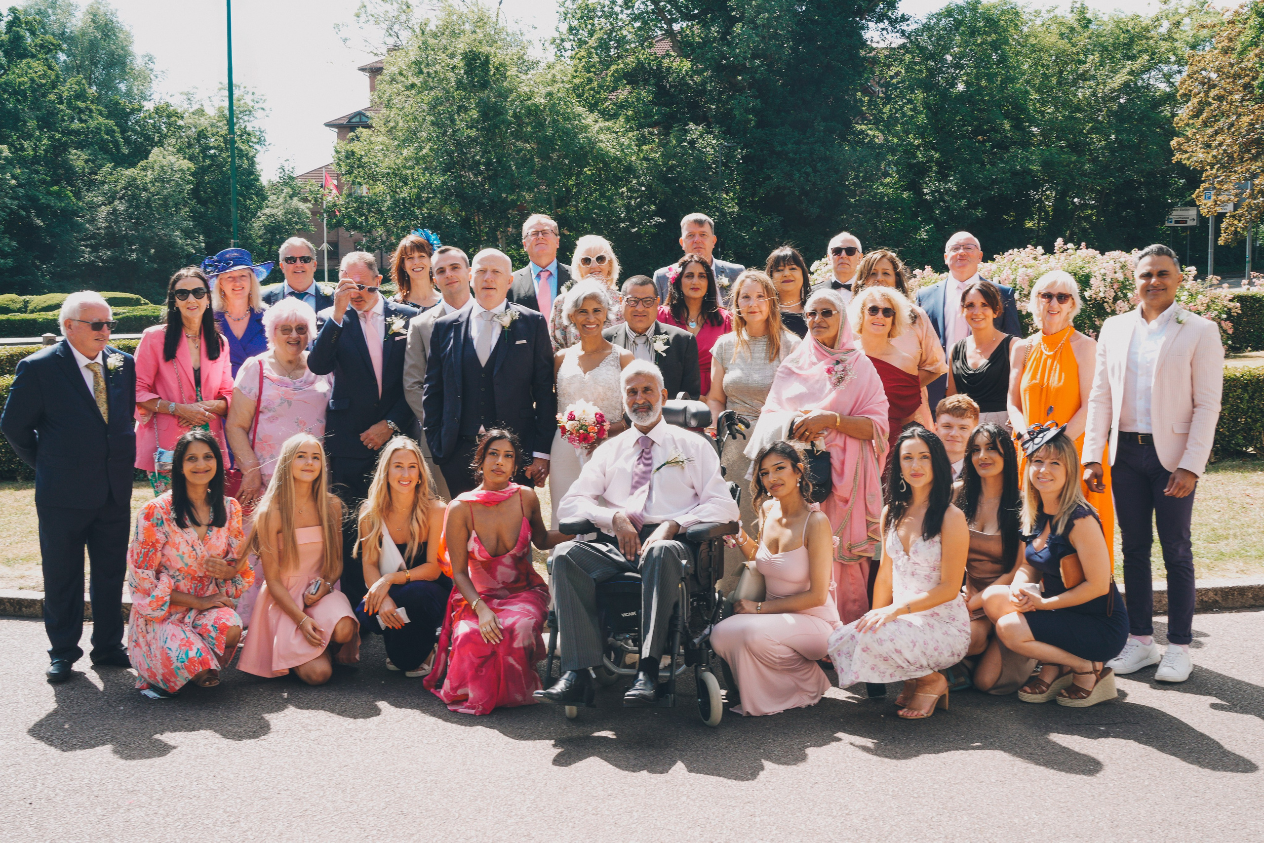 Joyful group photo with family and friends after the ceremony