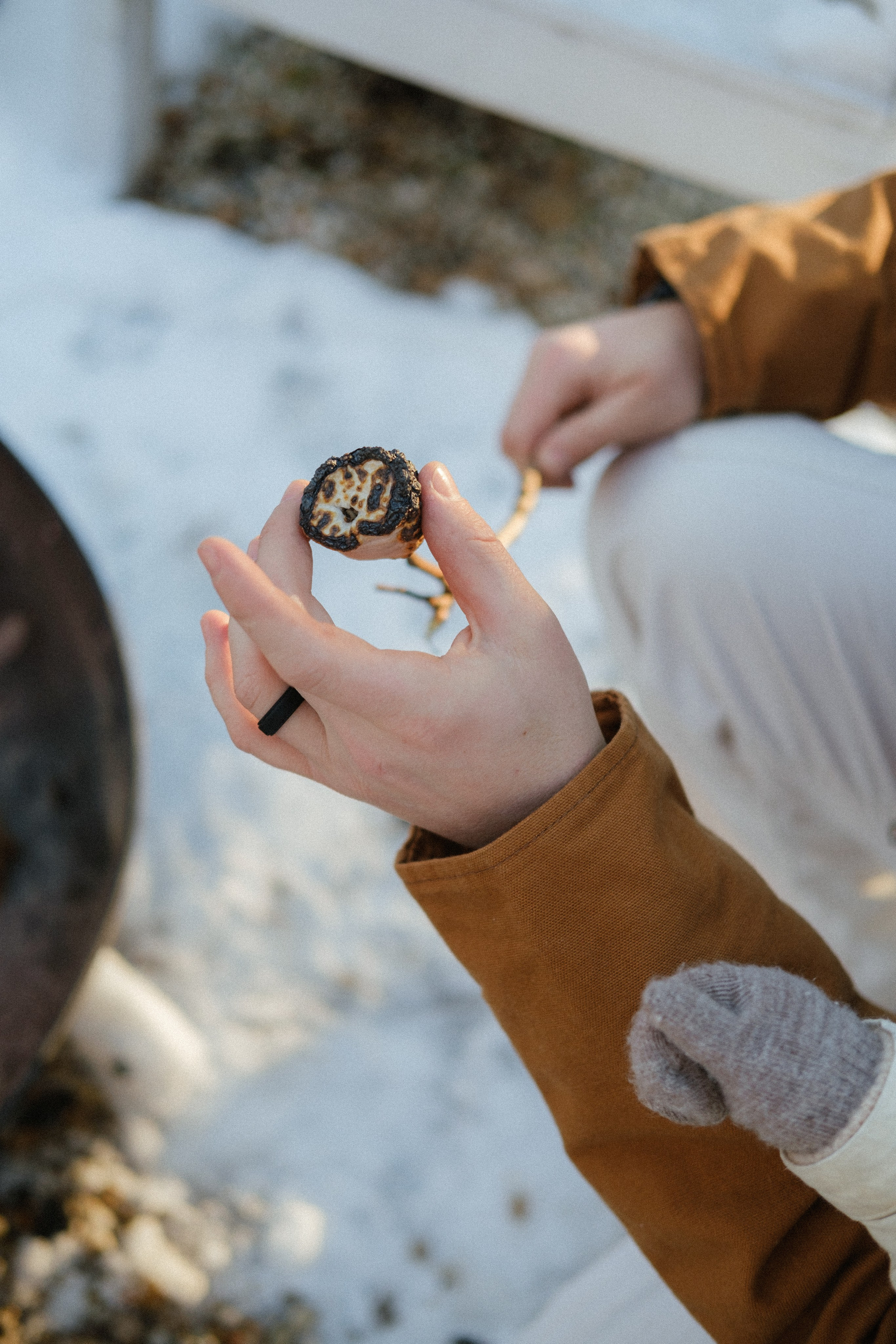 Detail shot of marshmallows roasting over an open fire in Richmond, VA — warm, nostalgic winter memory.