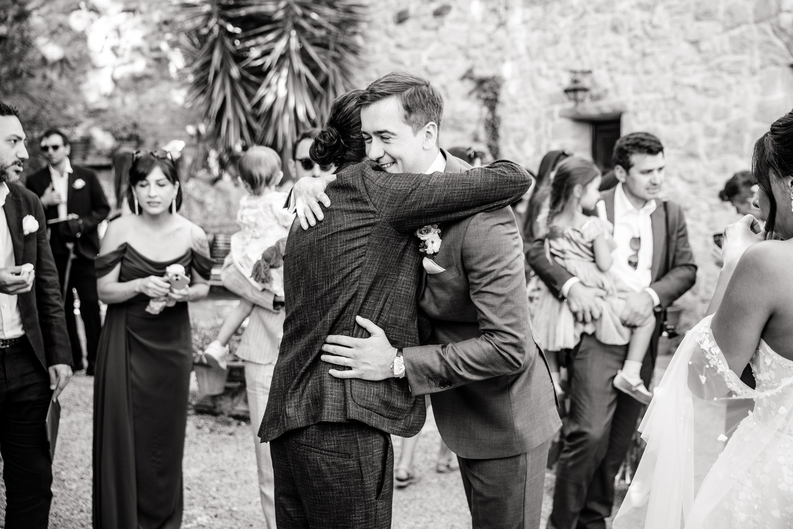 Candid shot of the bride hugging with friends