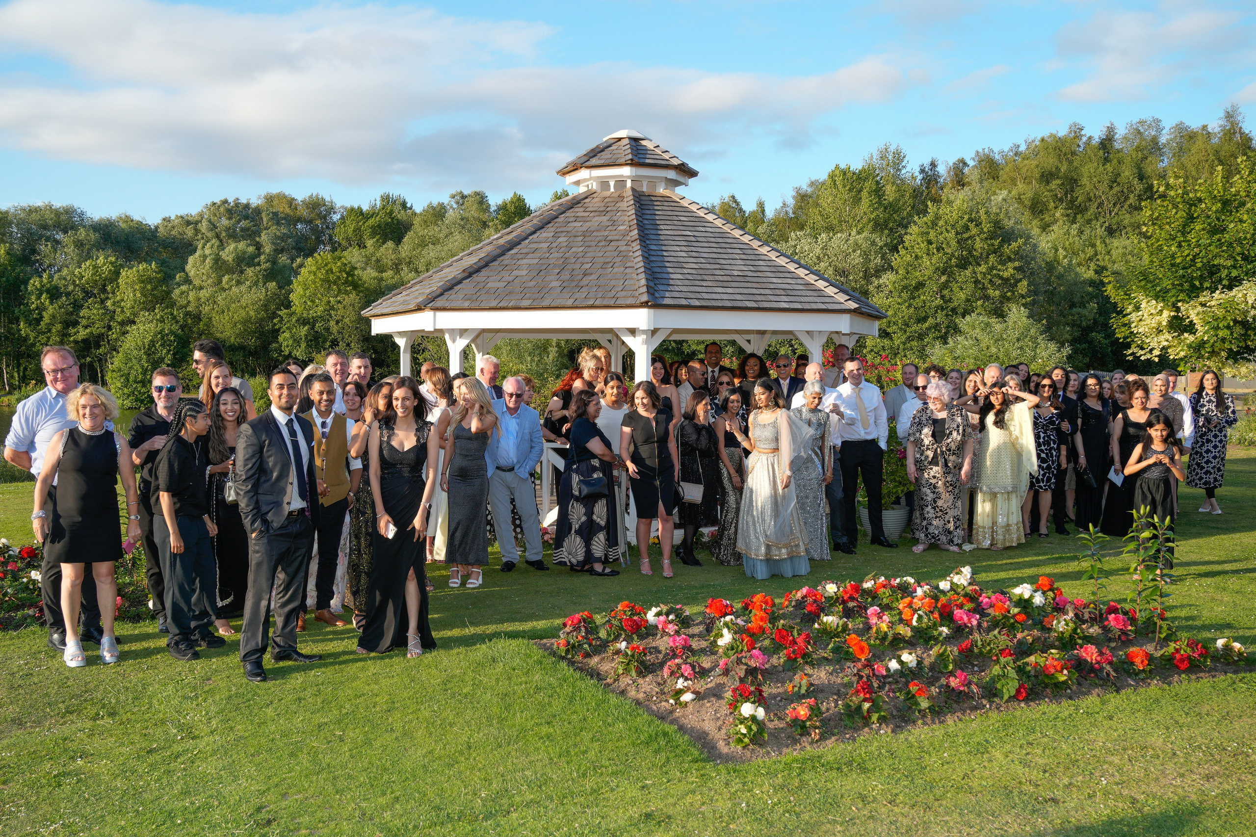 Group photo of family and friends in front of the wedding venue