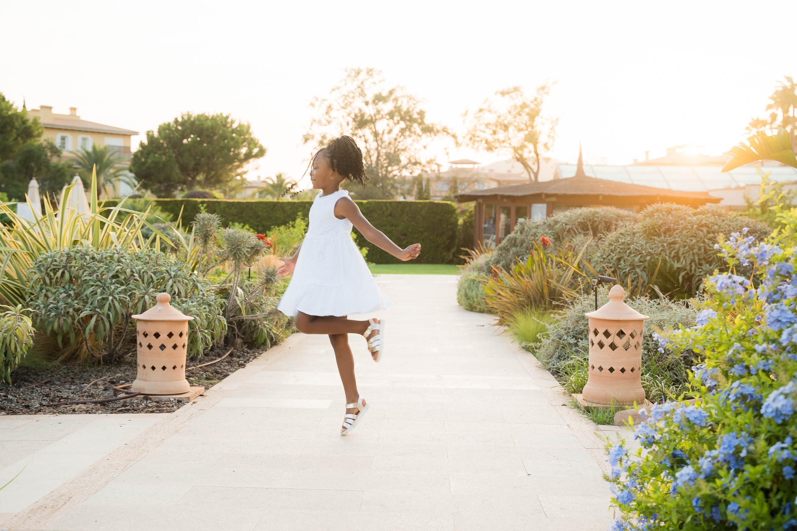 Child playing at St. Regis Mardavall in Mallorca while having her Portraits photographed