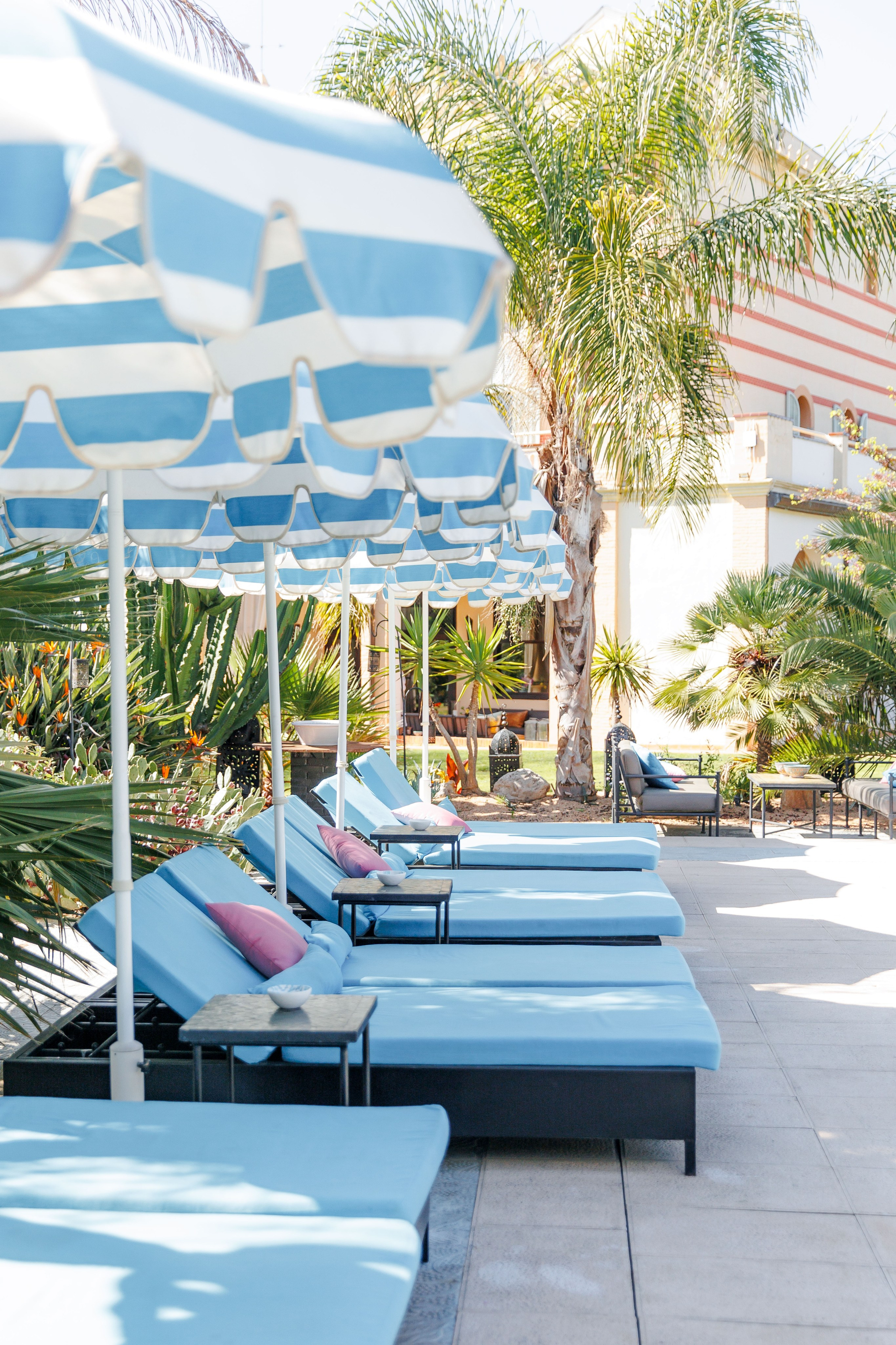 Swimming pool, umbrellas, and sunbeds at the wedding venue in Barcelona.