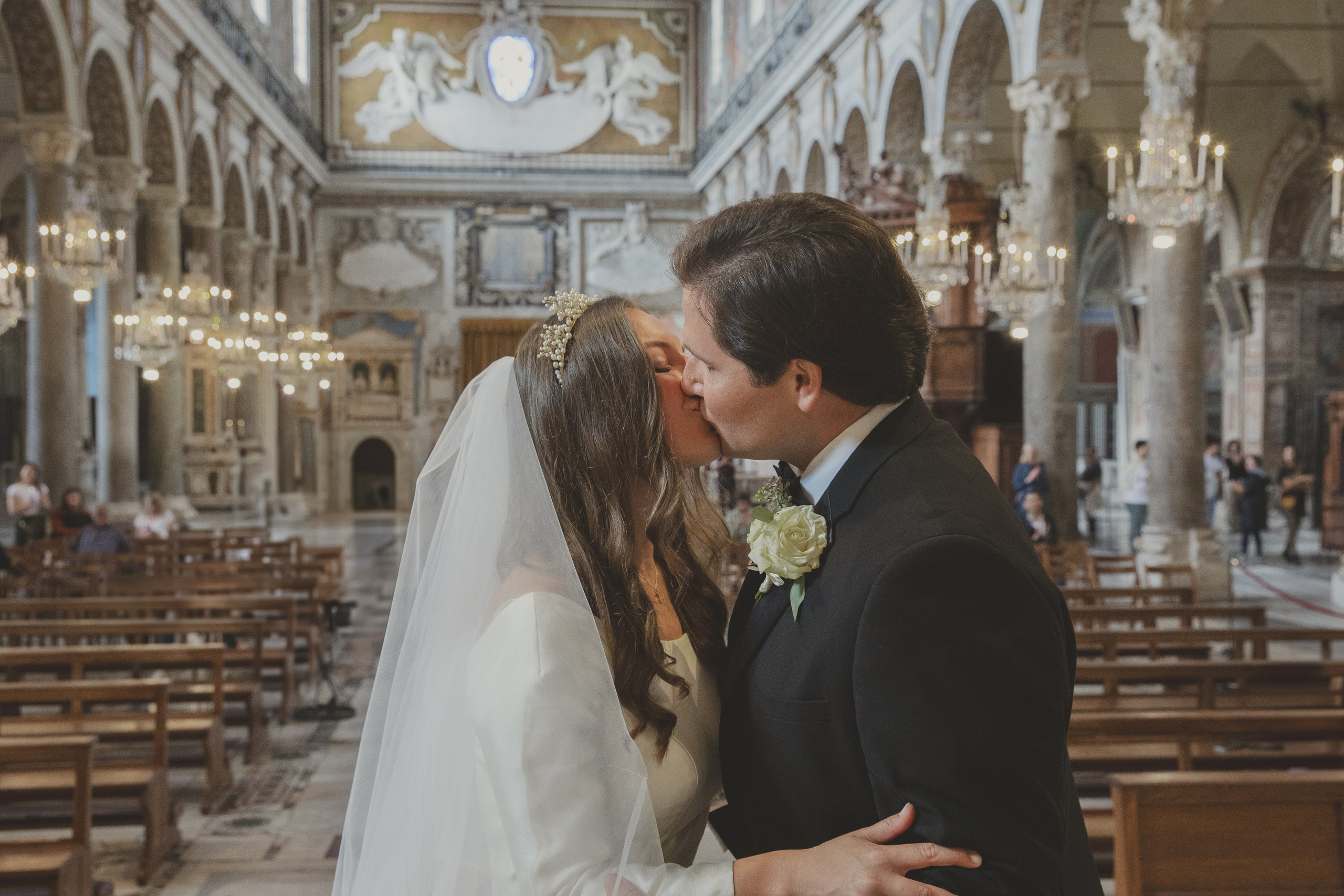 Couple kissing at the altar in Santa Maria in Aracoeli after saying 'I do'.
