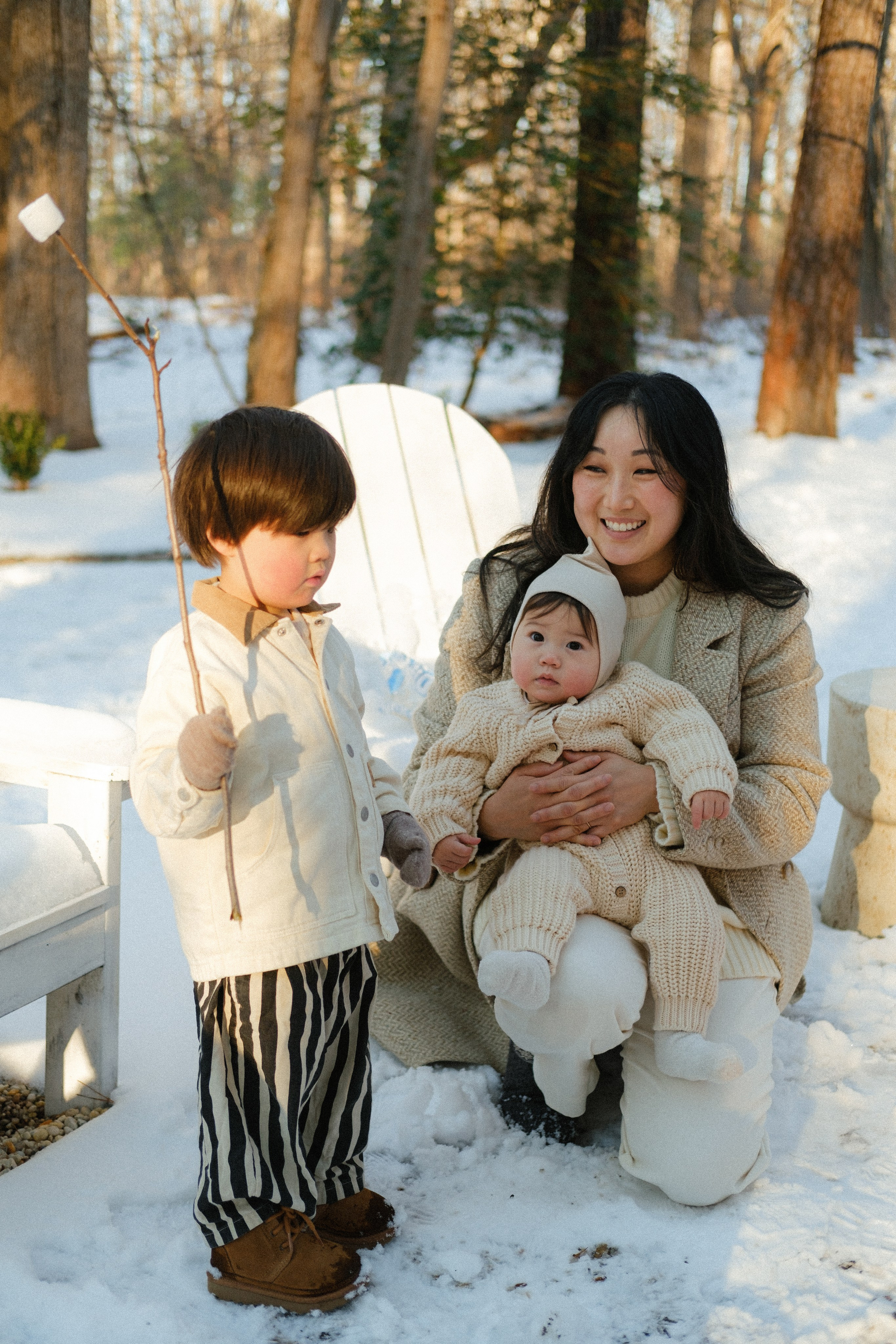 Kids roasting their first marshmallows over a fire in Richmond, VA — joyful winter memories in a snowy forest setting.