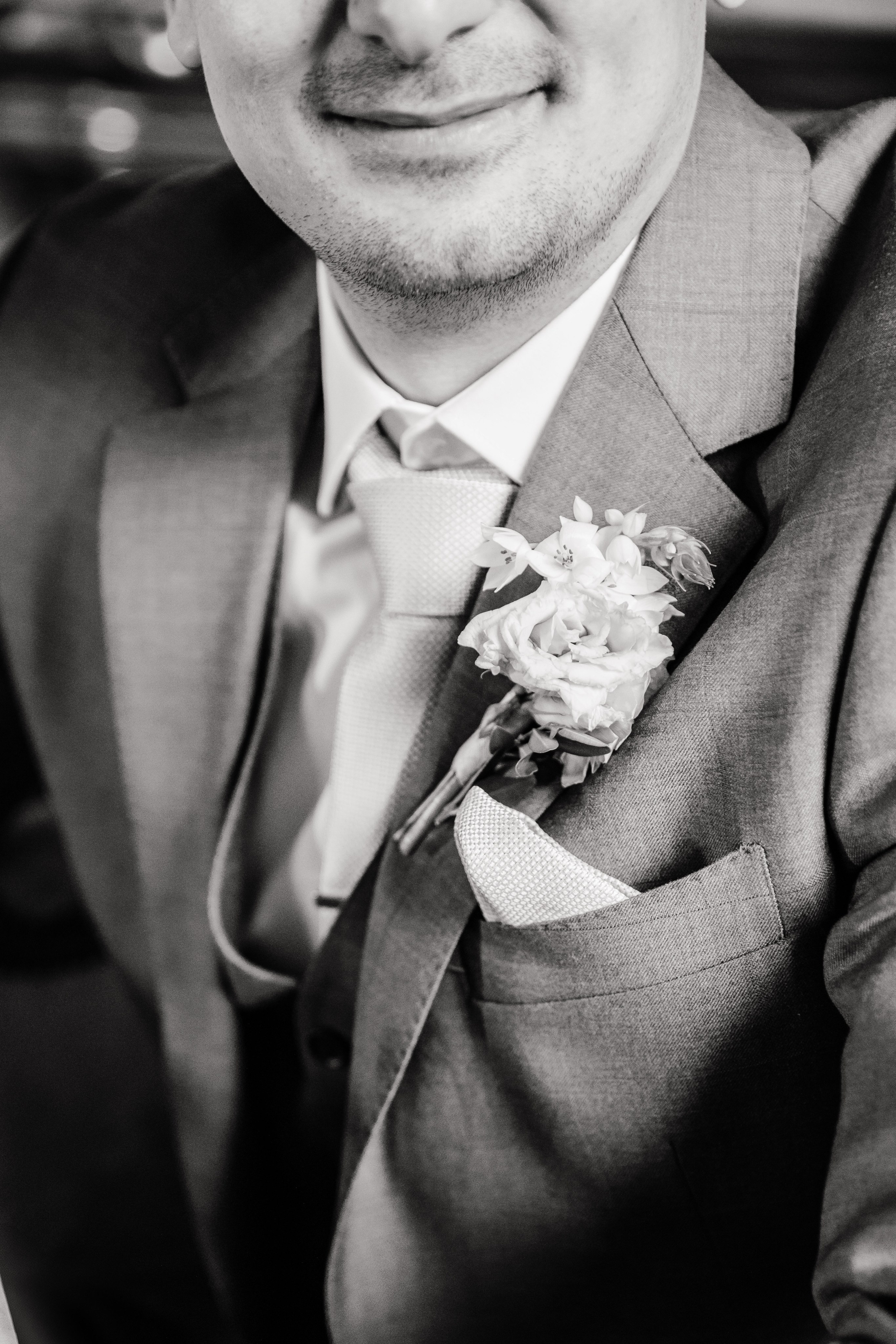 Groom adjusting his tie in an authentic Barcelona venue before the wedding ceremony, highlighting pre-wedding moments.