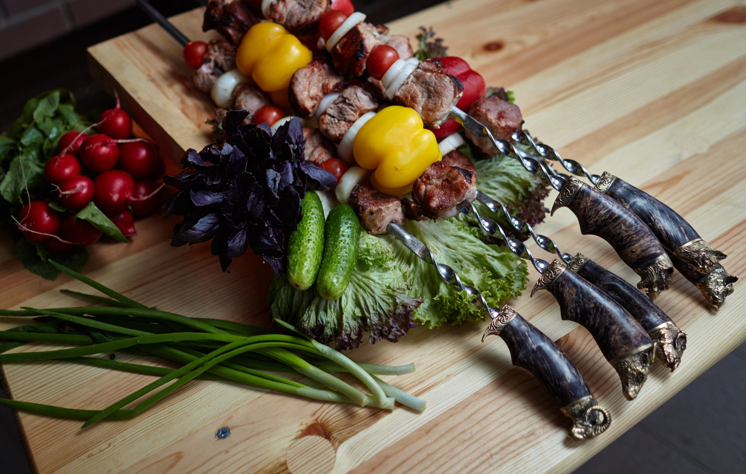 Présentation colorée de brochettes sur planche en bois avec citron, légumes et herbes – shooting culinaire France