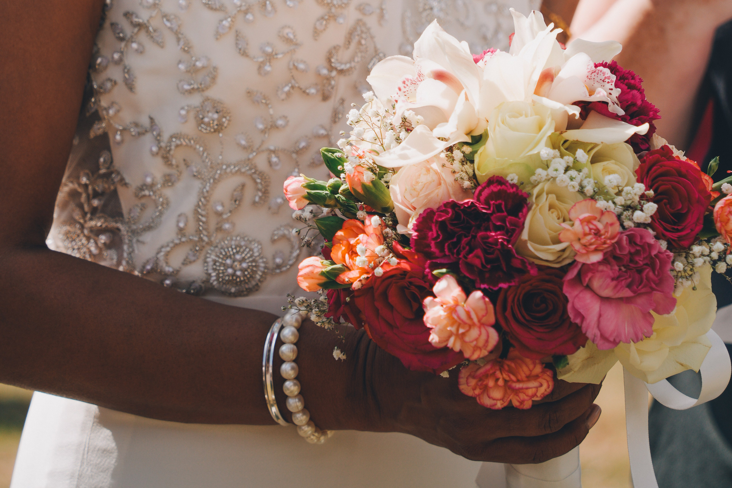 Close-up of wedding rings and bouquet at a Solihull celebration