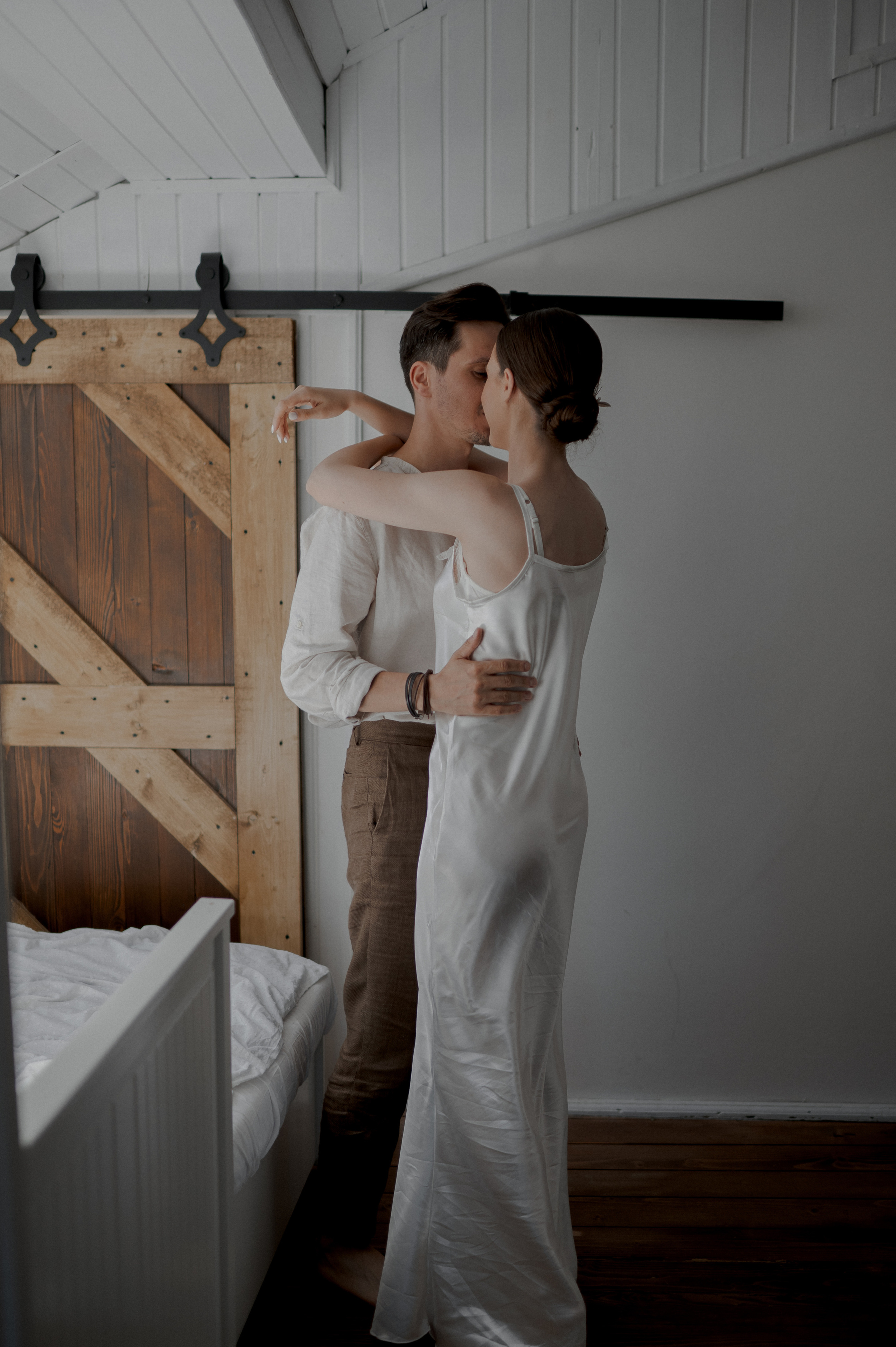 With hearts intertwined, the couple joyfully dances in the room, their graceful movements painting a picture of love and happiness, filling the space with an undeniable energy.