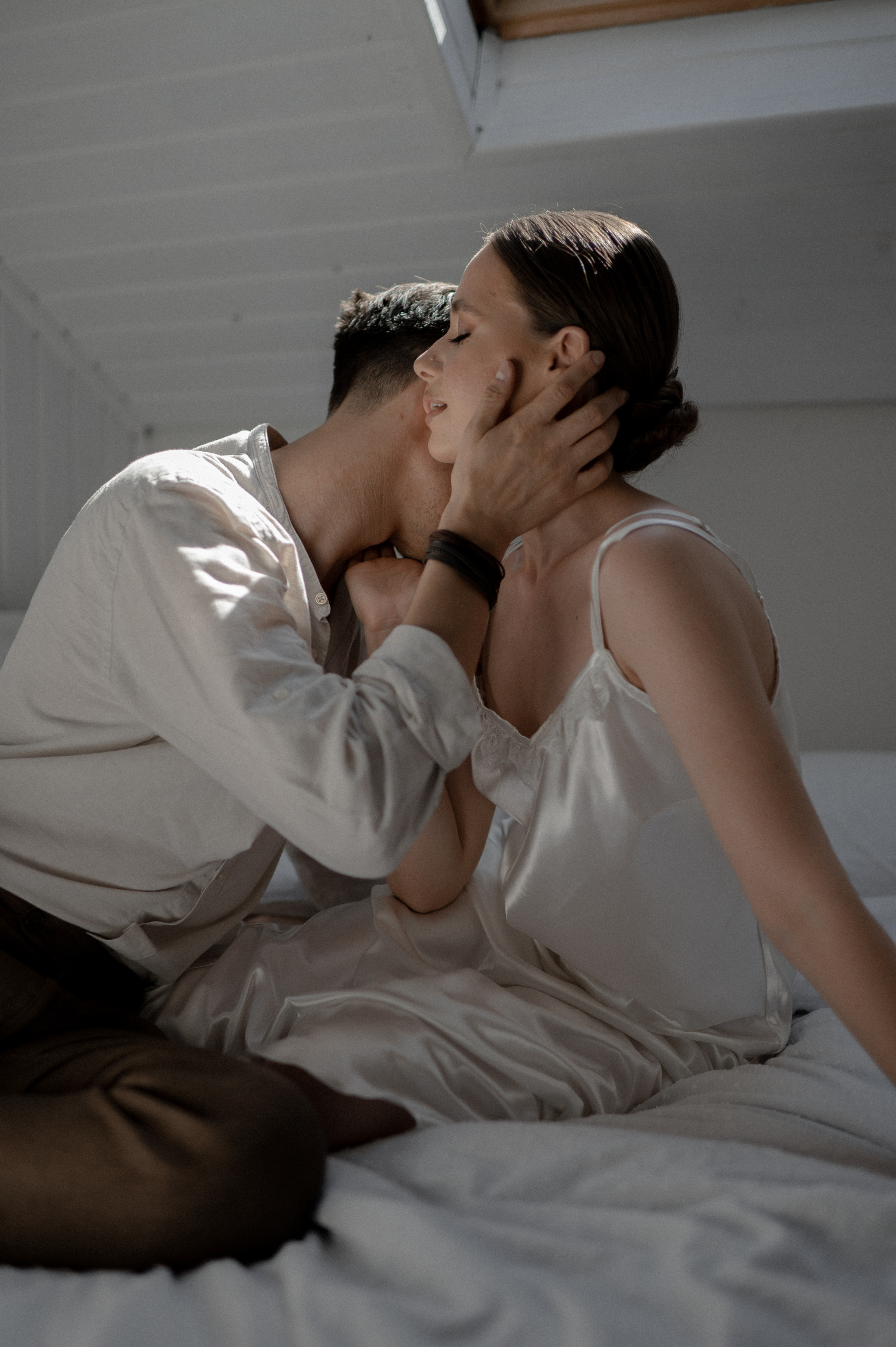 In the embrace of love, the couple enjoys cherished moments in bed, fueling excitement and anticipation for their wedding day.