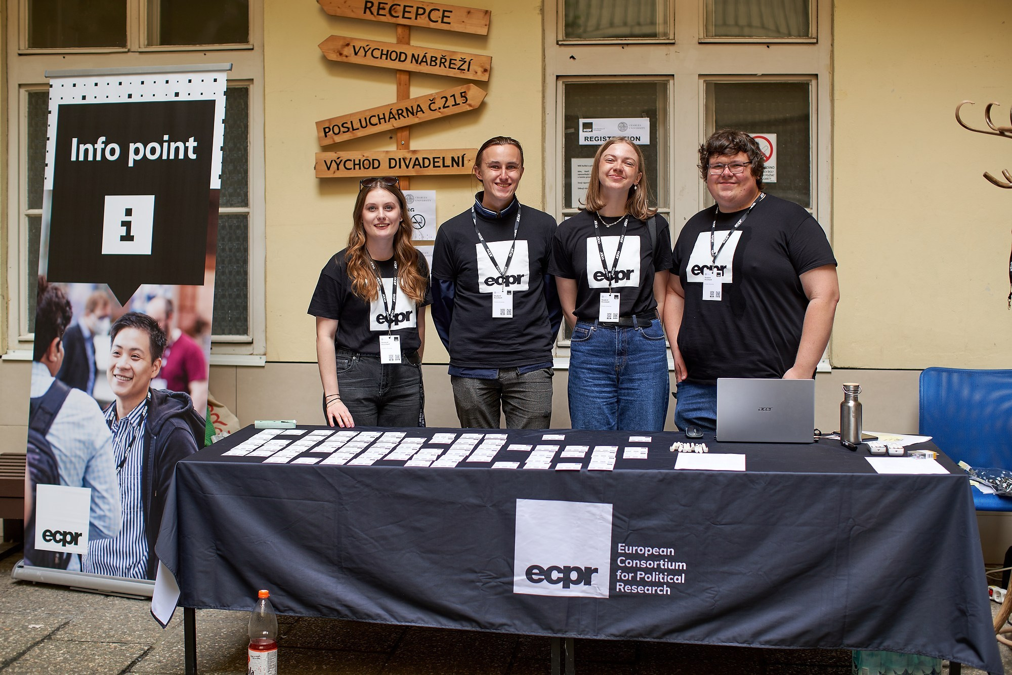 Staff members pose for a photo as they wait to welcome attendees to the ECPR event at Charles University.