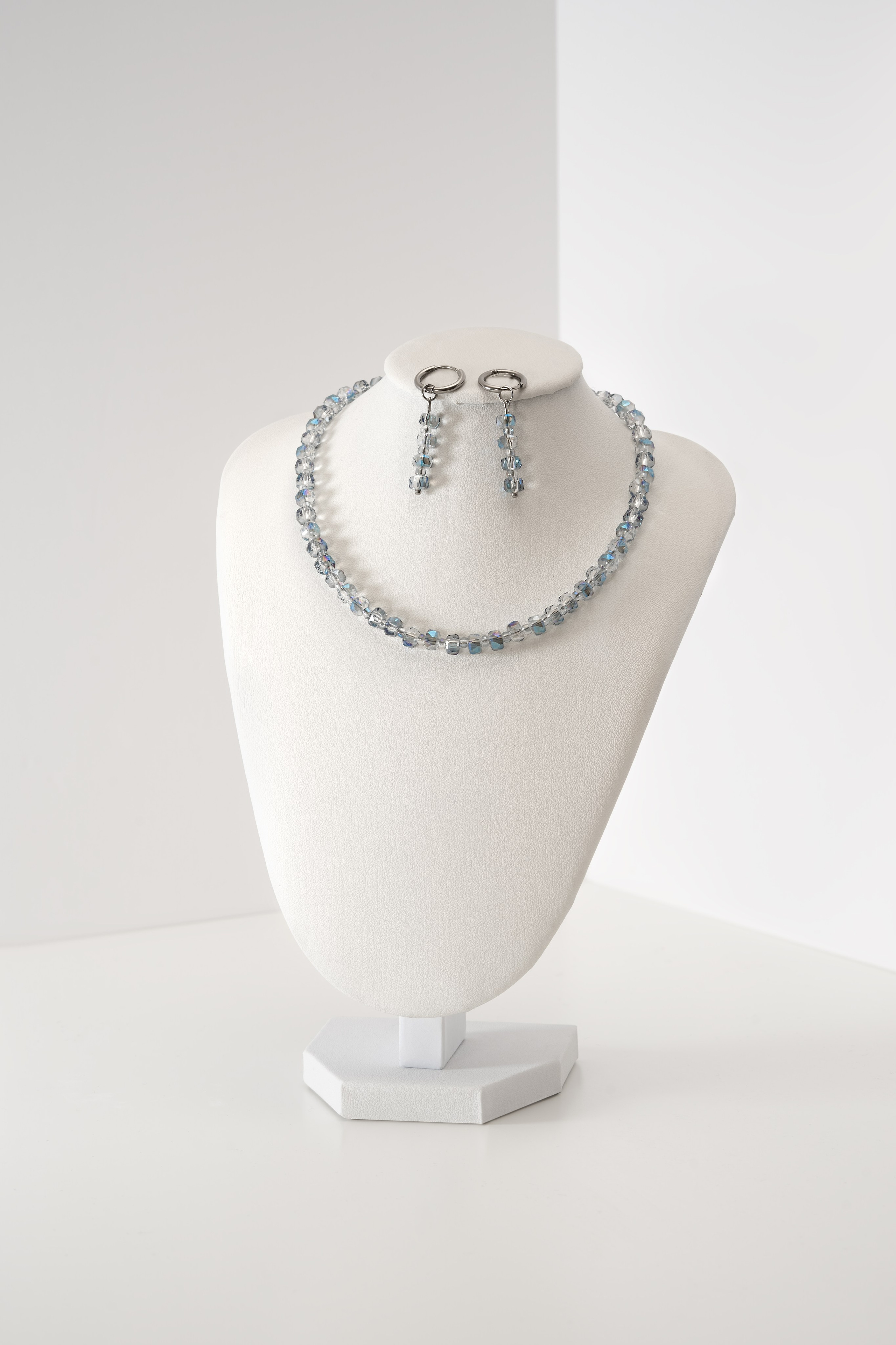 Professional product photography of a silver pendant for online catalogs.