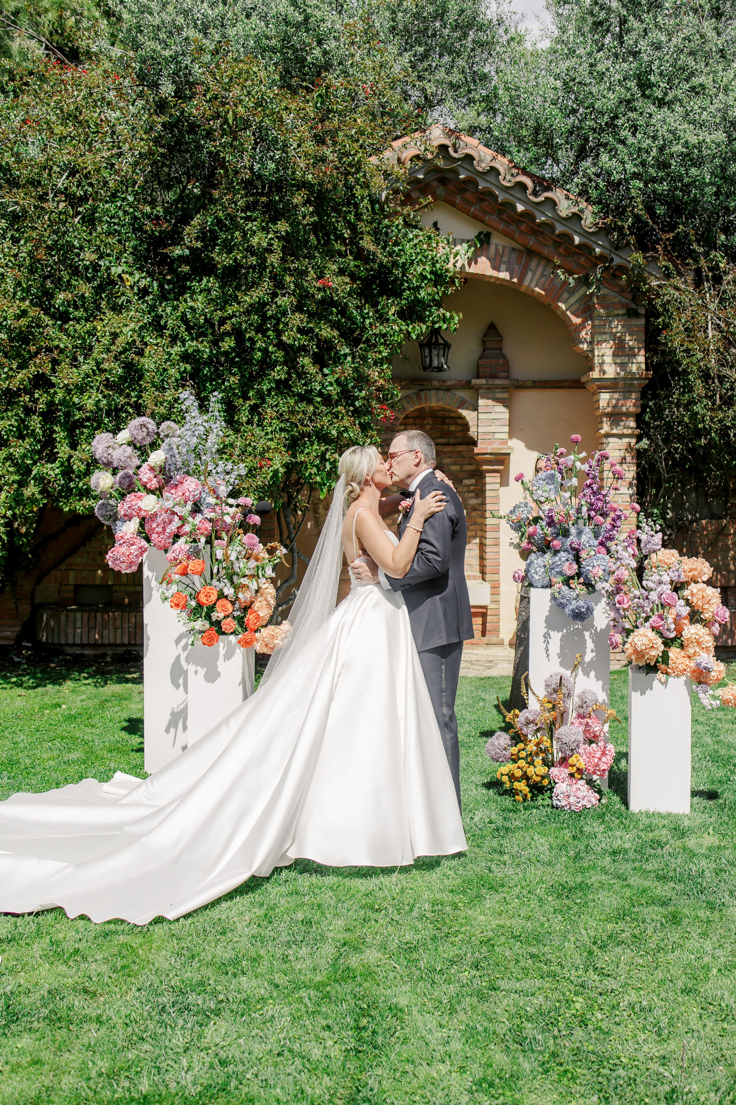 Groom and bride exchanging a kiss at a luxury destination wedding in Costa