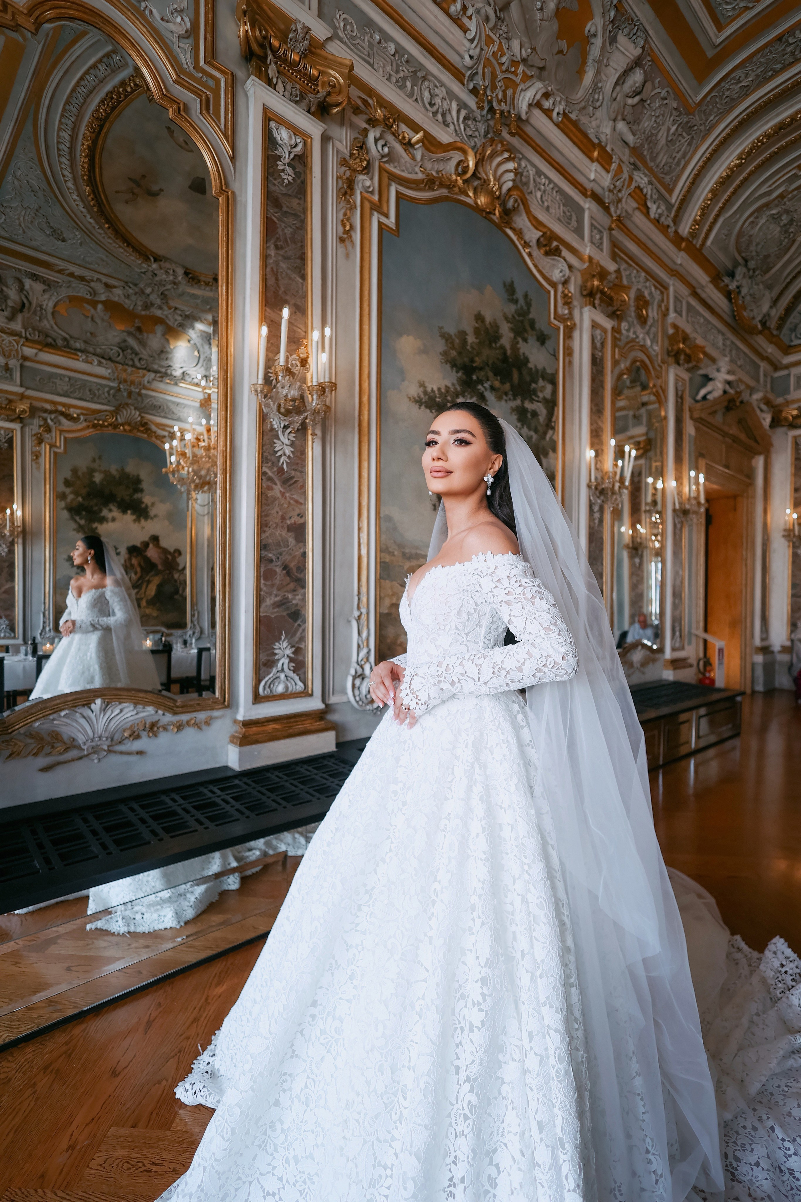Armenian bride in white dress standing in the serene courtyard of Aman Venice