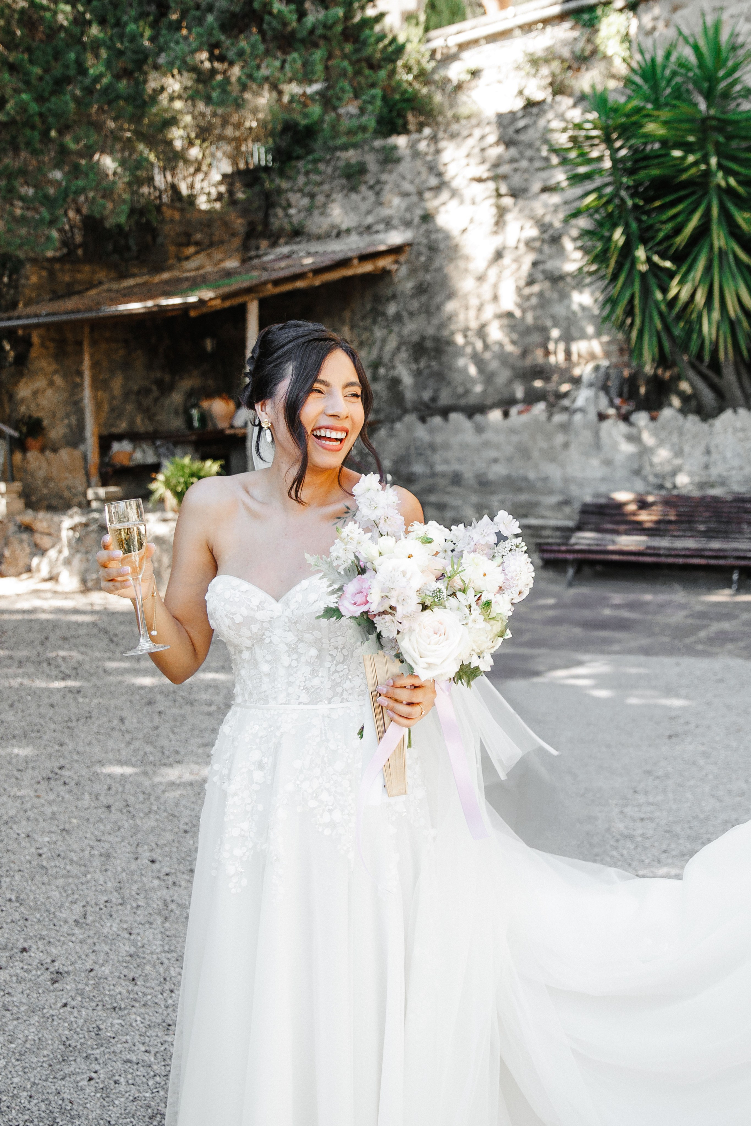Candid shot of the bride laughing with friends during pre-wedding festivities in Barcelona.
