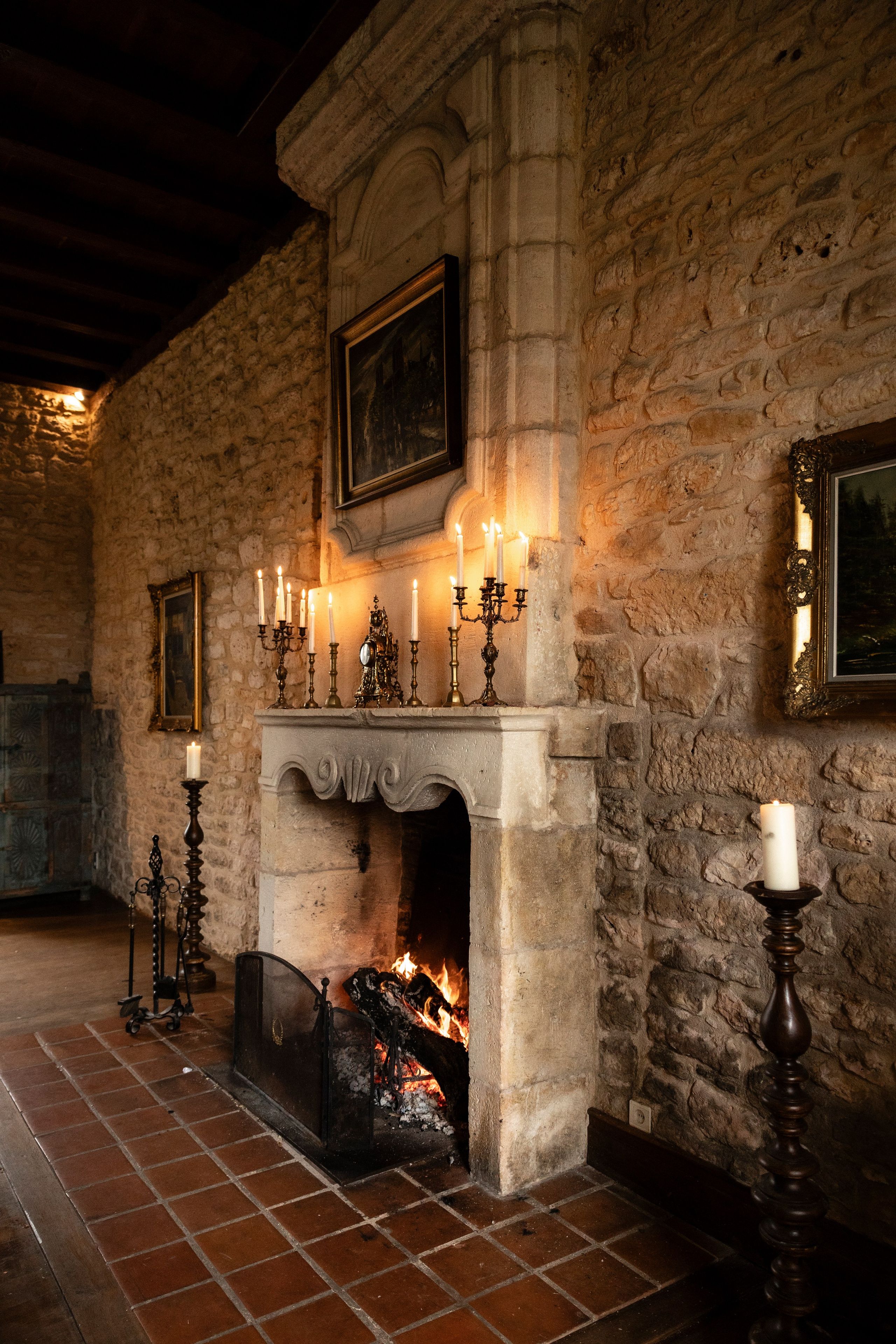 Rainy-day wedding at Château Lagut with indoor ceremony setup by the fireplace.