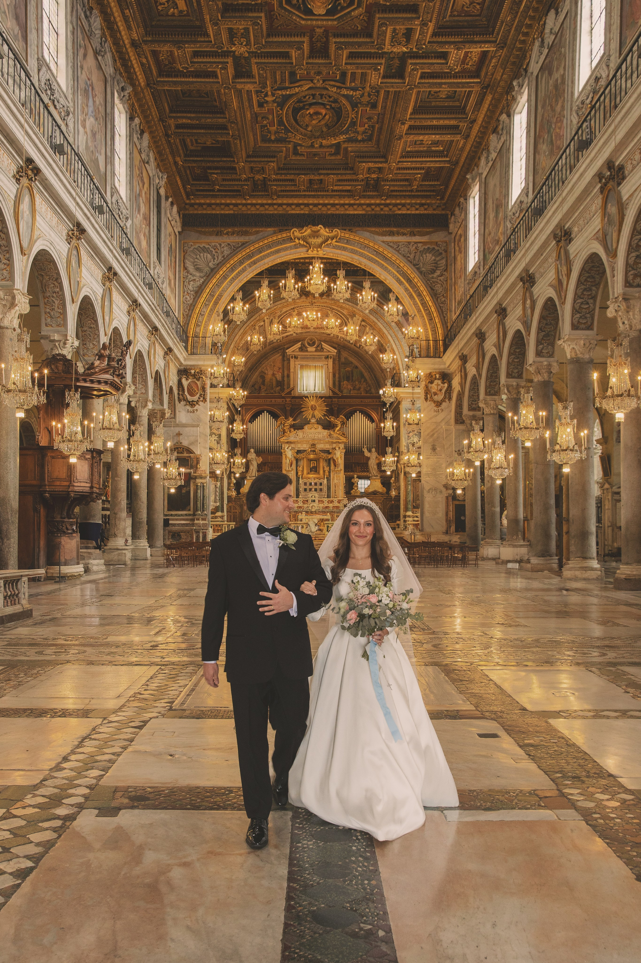 Couple walking down the aisle after their wedding ceremony at Santa Maria in Aracoeli.