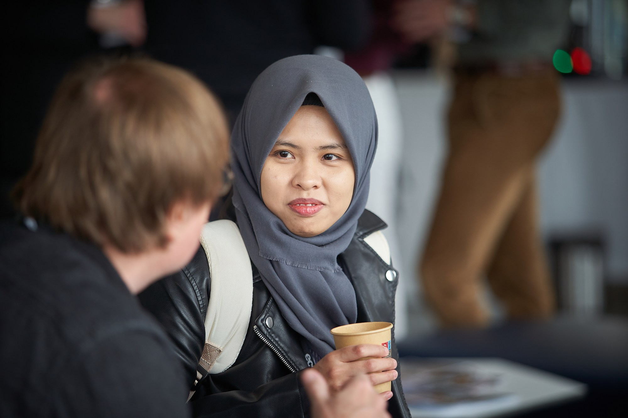 A scholar listens to a colleague during a break at the ECPR conference.