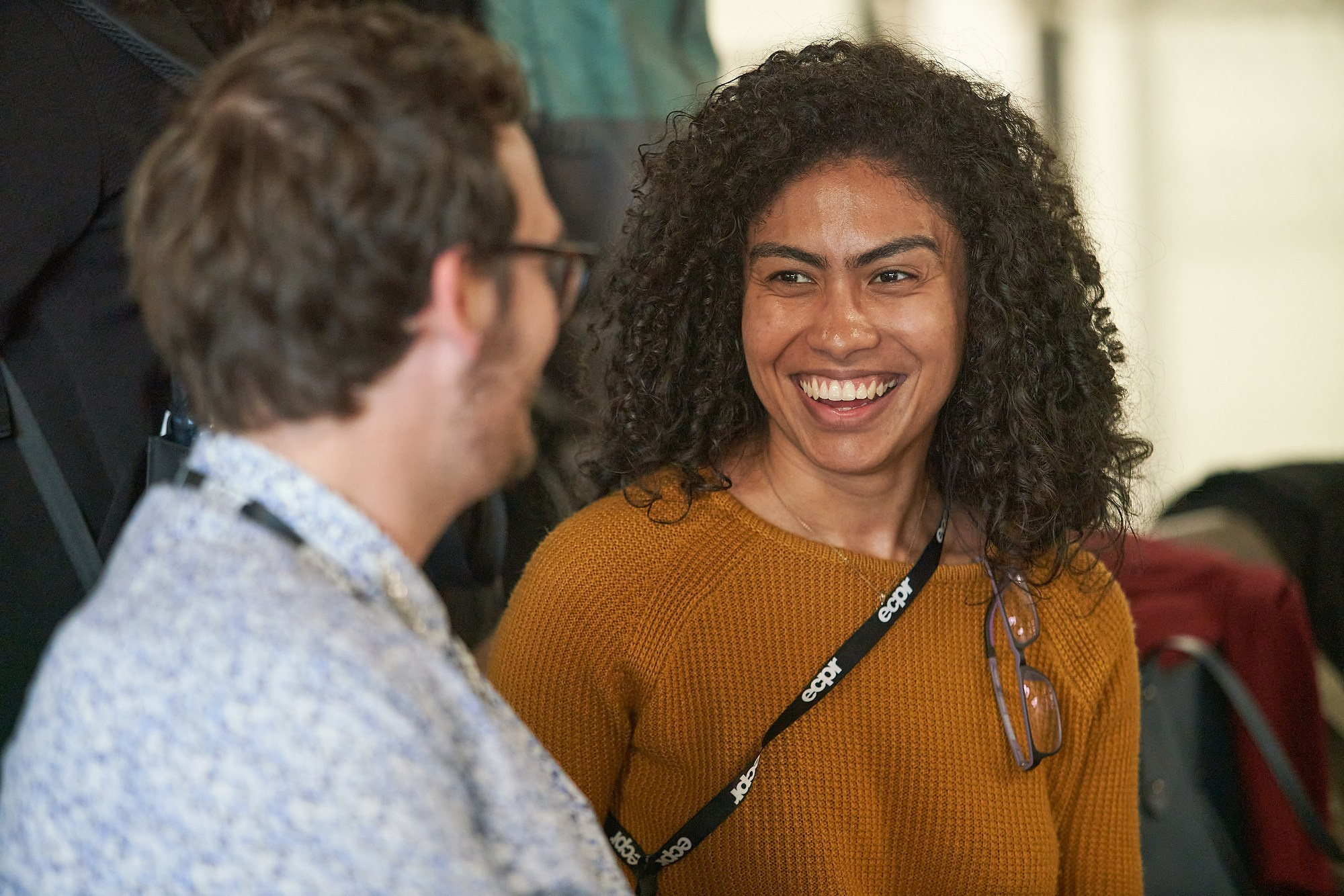 Two attendees share a laugh during the ECPR conference in Prague.