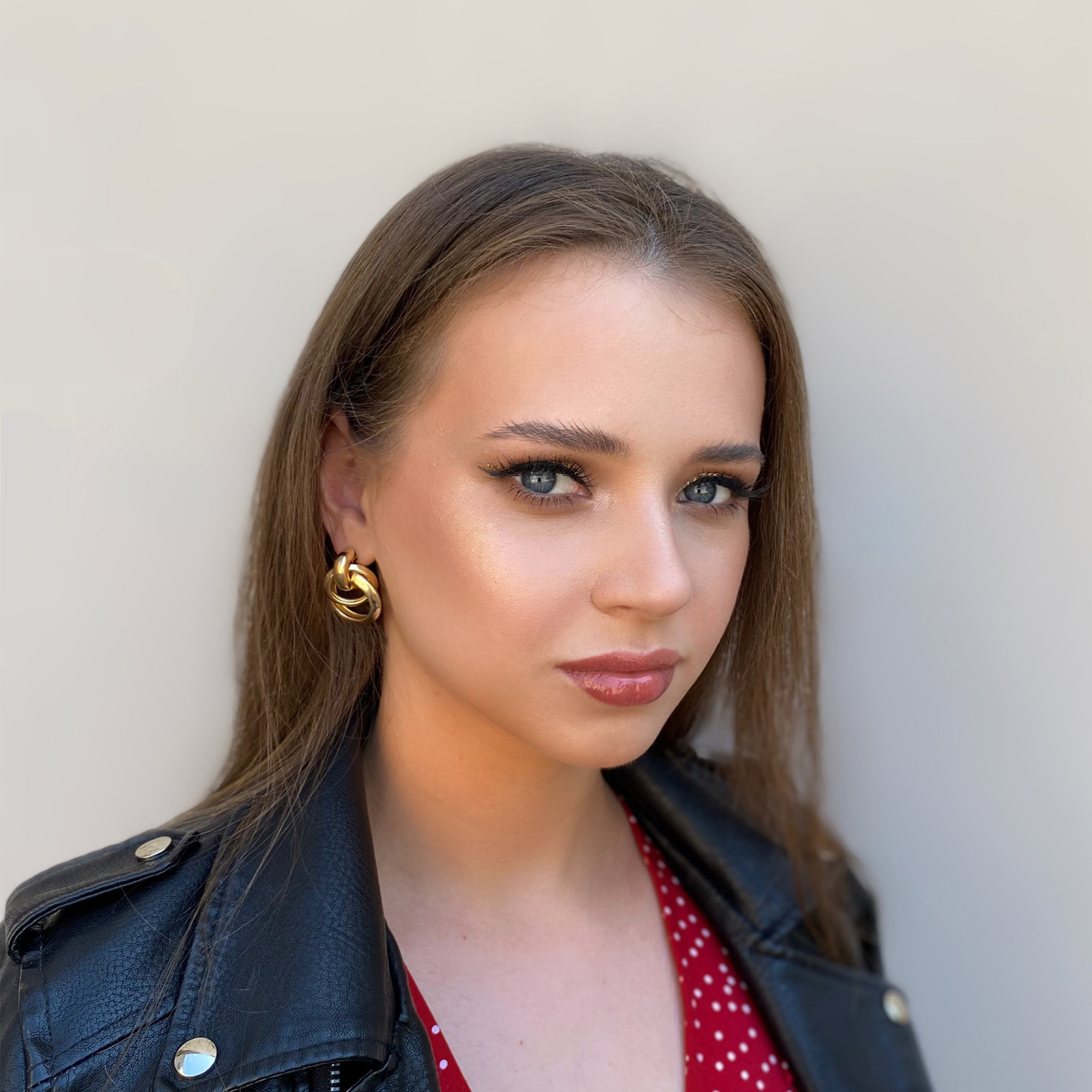 a bridesmaid with sharp black and golden glitter eyeliner with false eyelashes and glossy lips