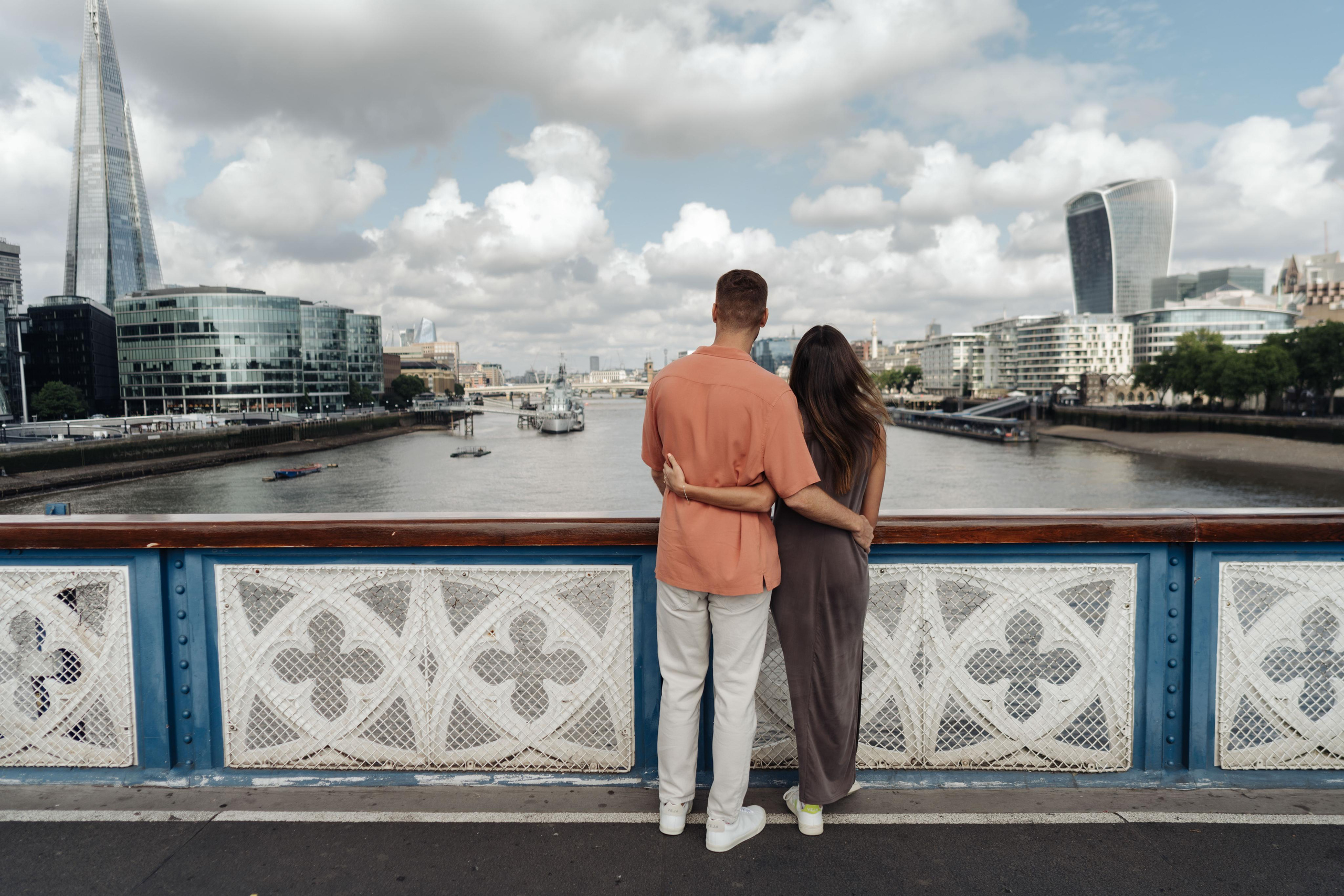young couple admiring city landscape from the bridge
