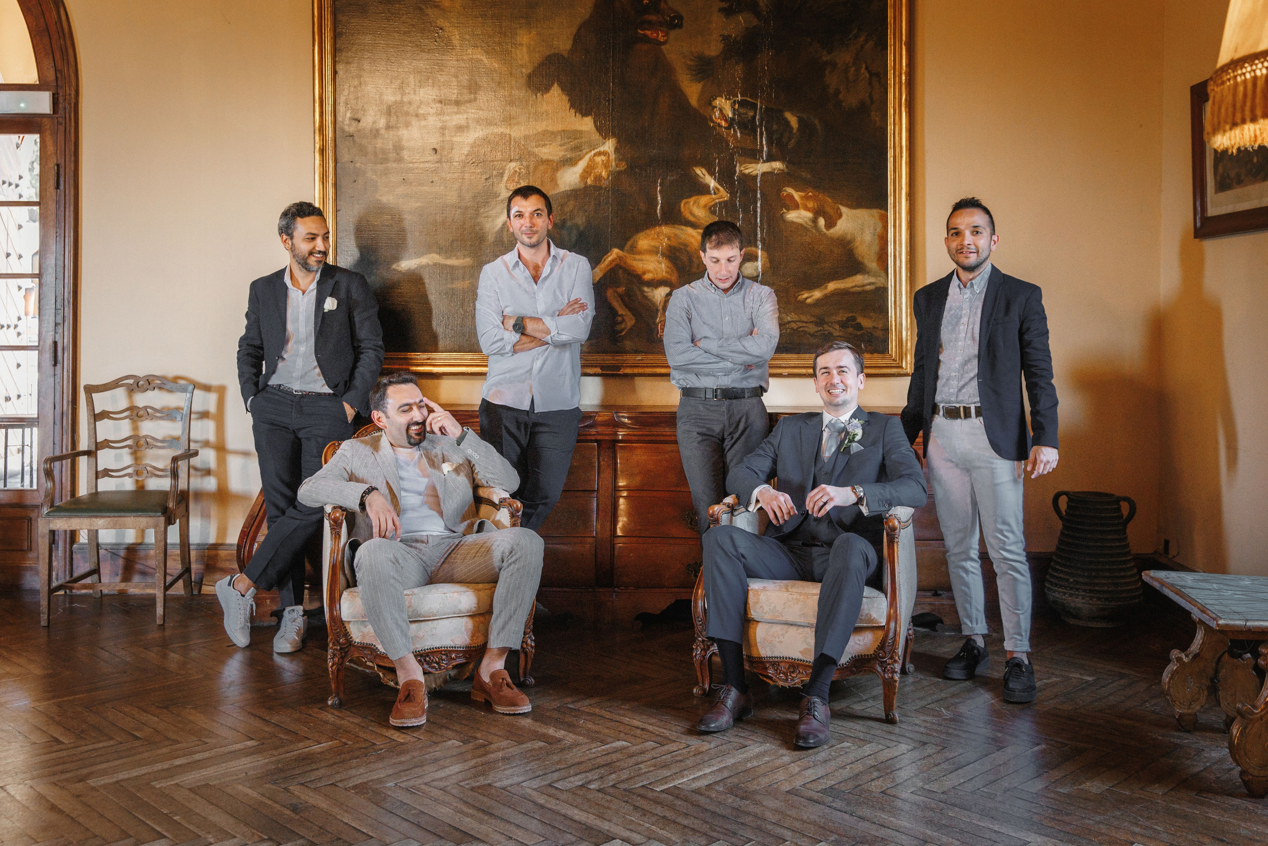 Groom posing with his groomsmen in a vibrant Barcelona venue, capturing friendship and joy on the wedding day.