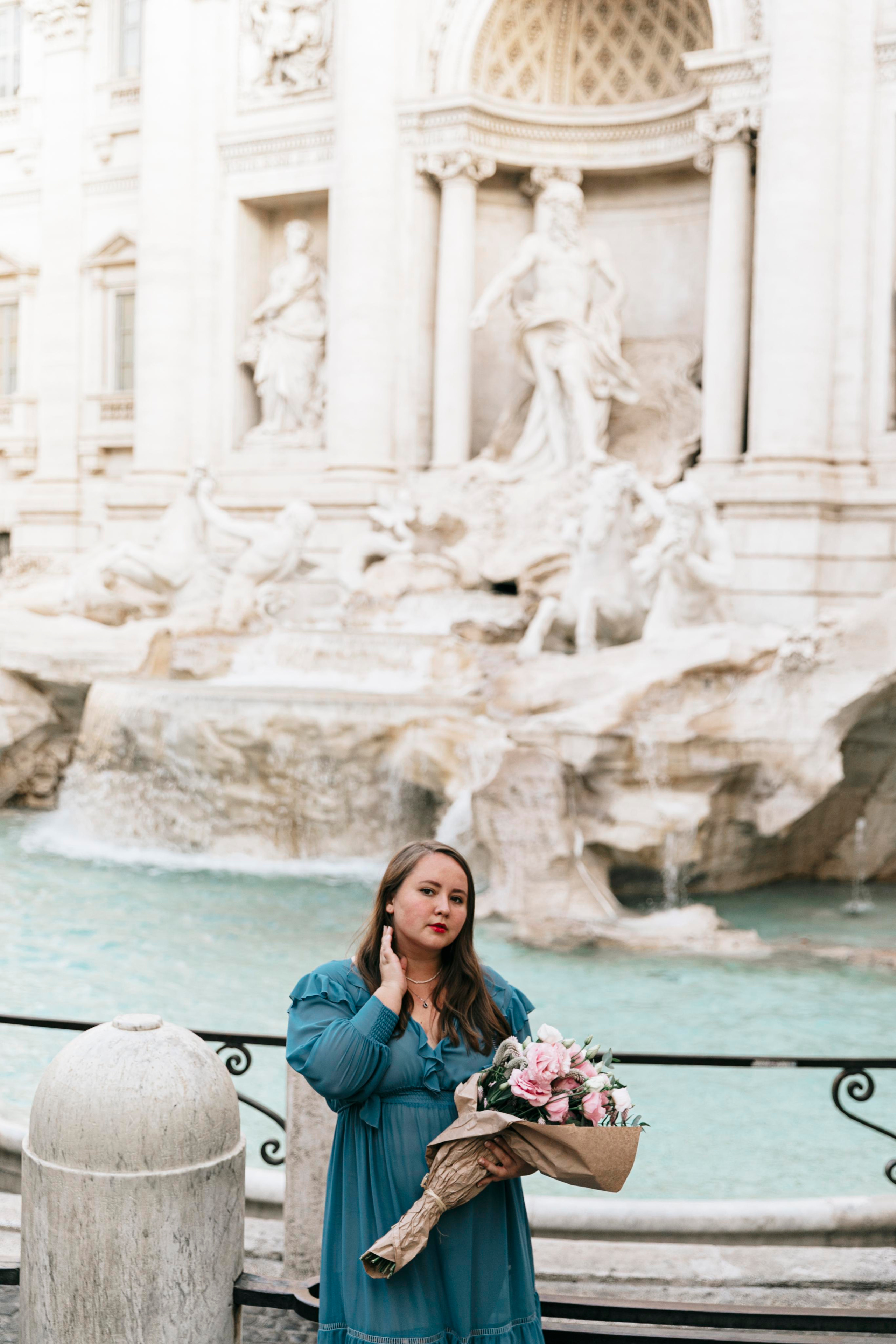THREE COINS IN THE TREVI FOUNTAIN. Photographer in Rome
