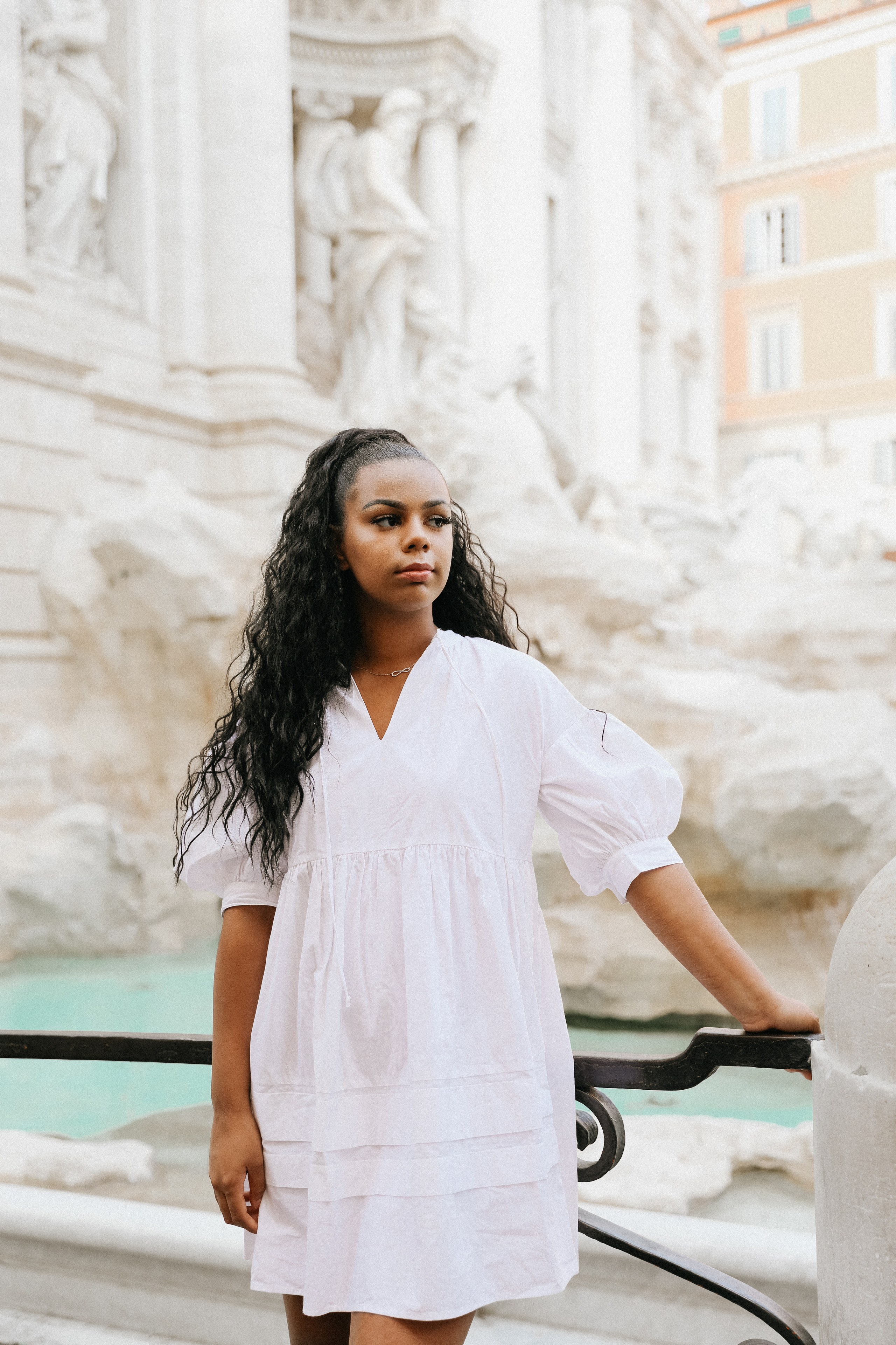 THREE COINS IN THE TREVI FOUNTAIN. Photographer in Rome