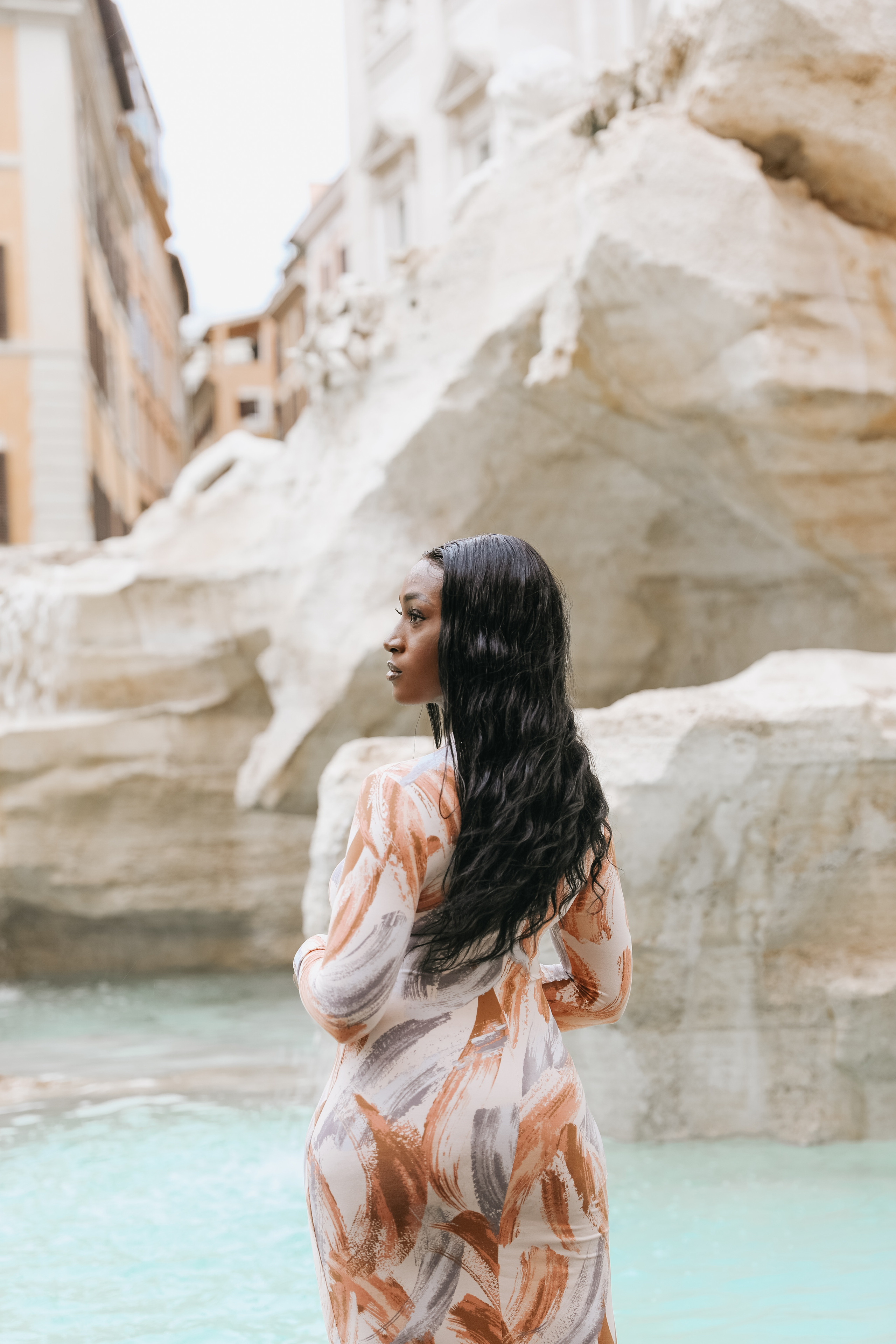 THREE COINS IN THE TREVI FOUNTAIN. Photographer in Rome