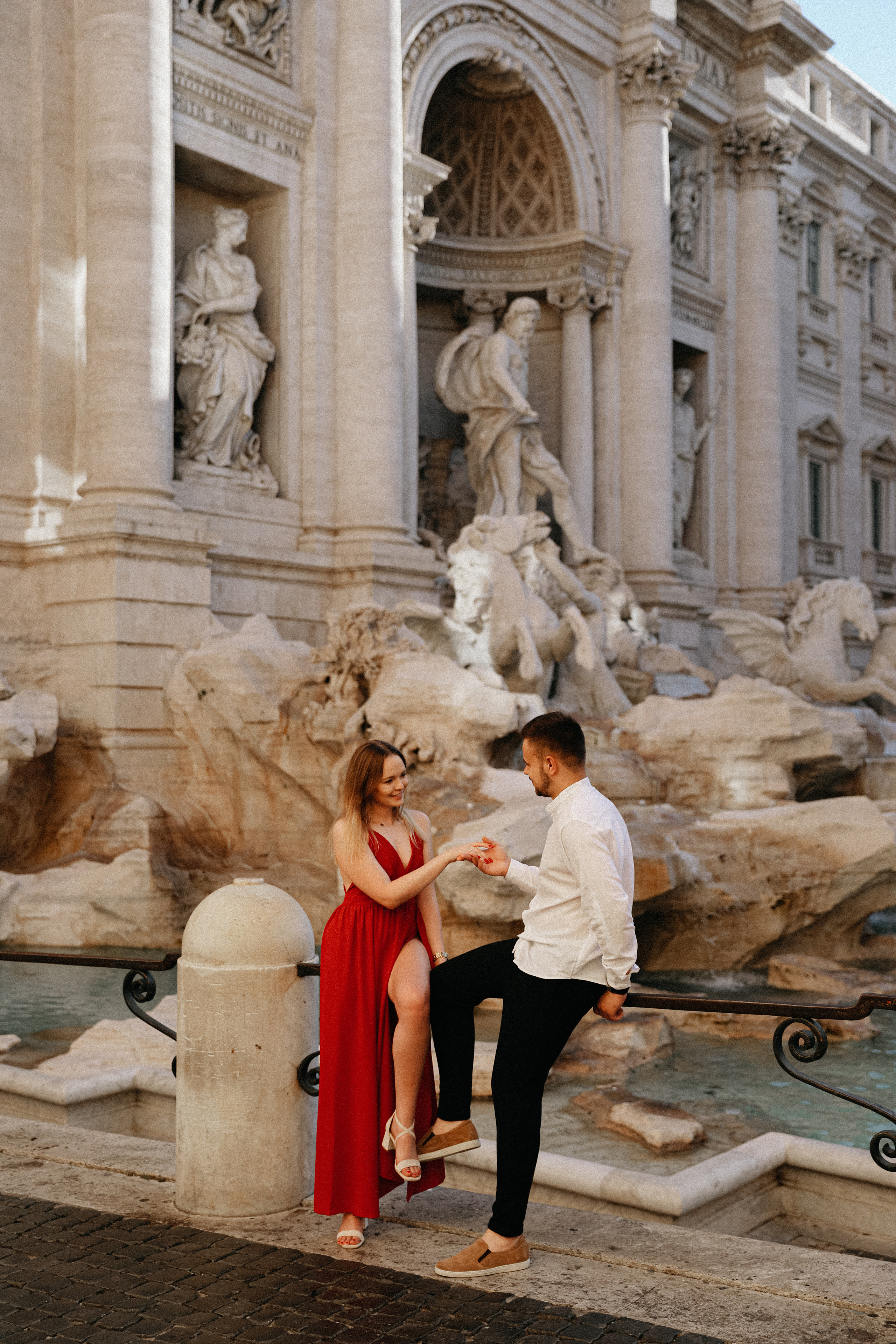 THREE COINS IN THE TREVI FOUNTAIN. Photographer in Rome