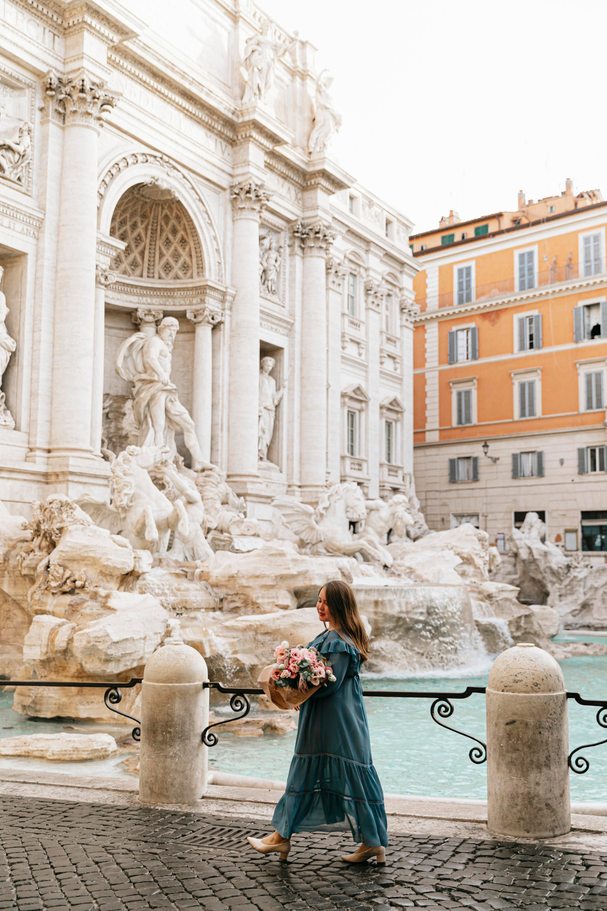 THREE COINS IN THE TREVI FOUNTAIN. Photographer in Rome