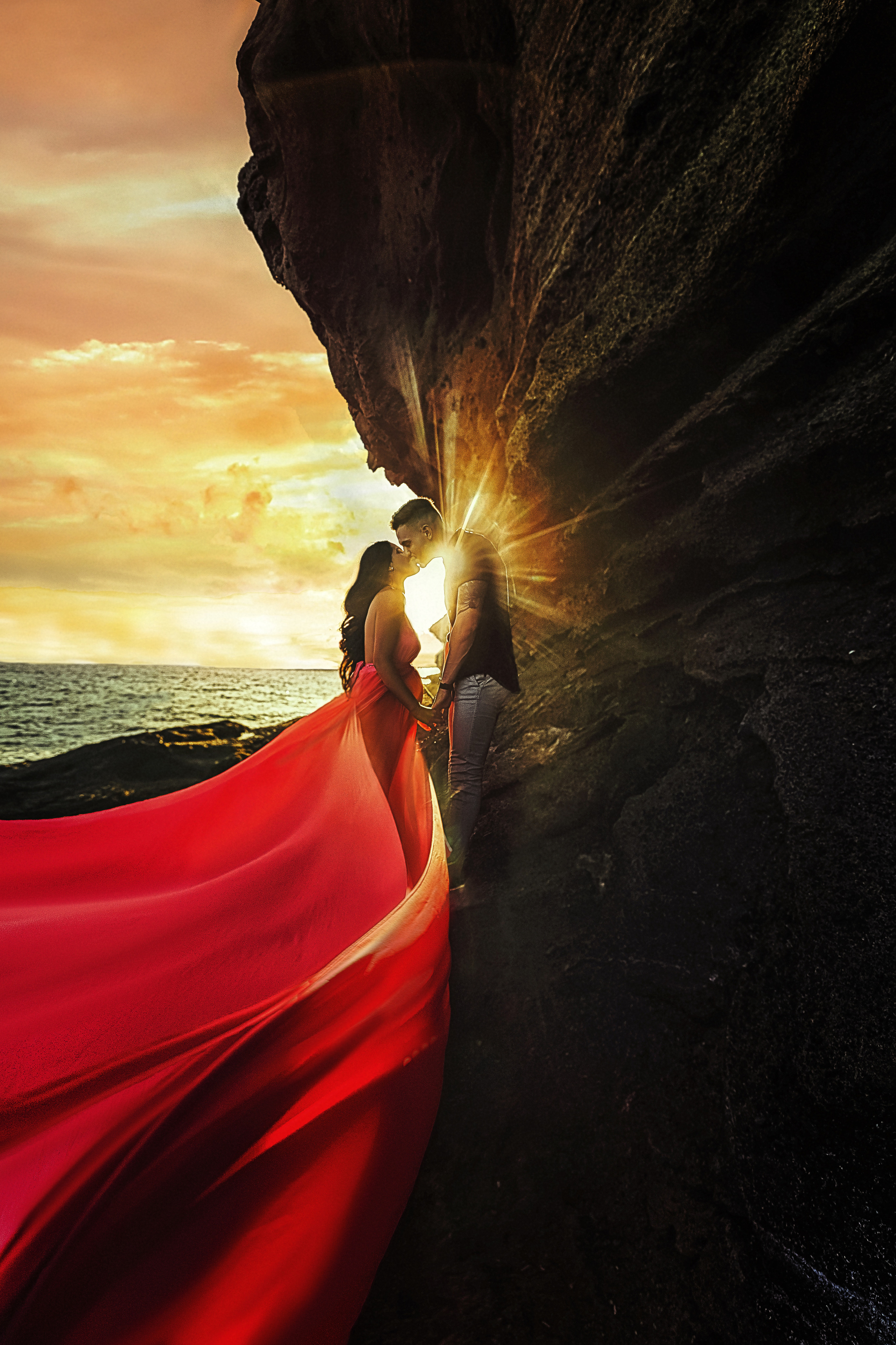 A couple kissing with the sunset in the background