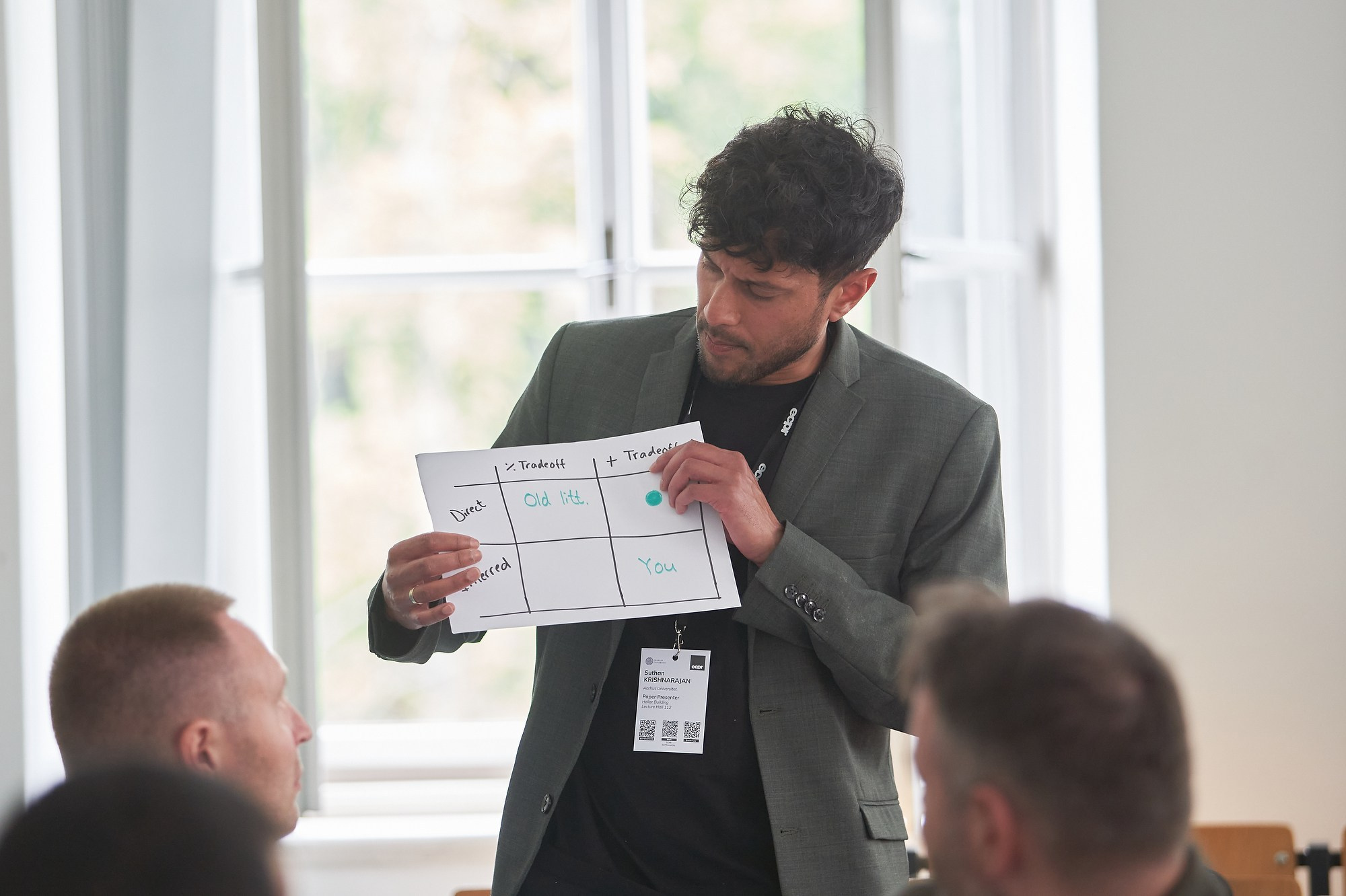 A workshop attendee discusses his findings in a small classroom during the ECPR conference at Charles University.