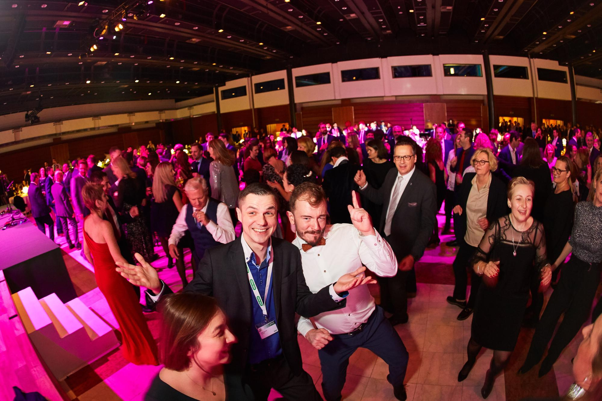 Attendees live it up on the dance floor as a band performs on state.