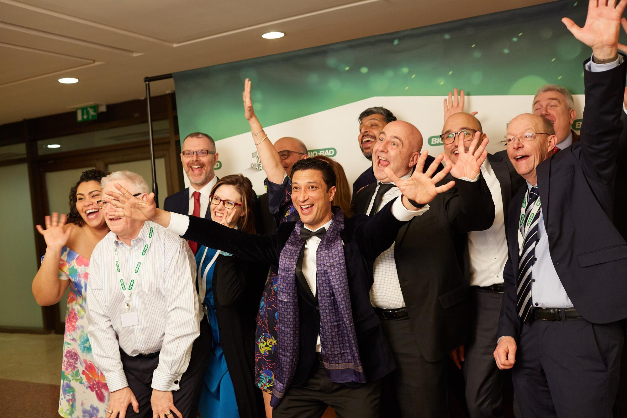 Bio-Rad employees pose for a photo at a photo booth.