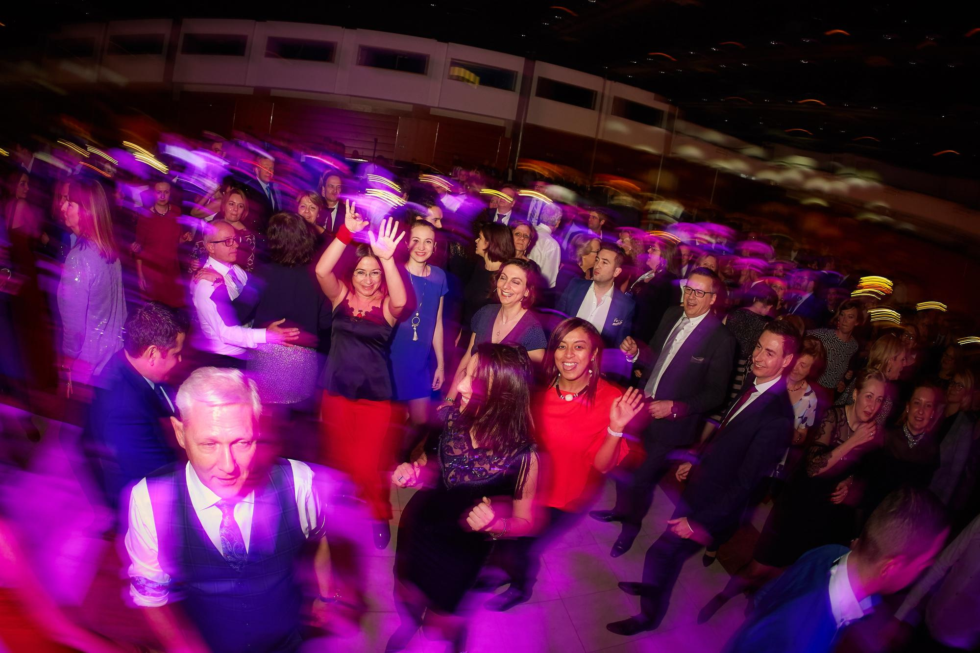 Bio-Rad employees are bathed in a purple light during the night's gala party held in their honor.