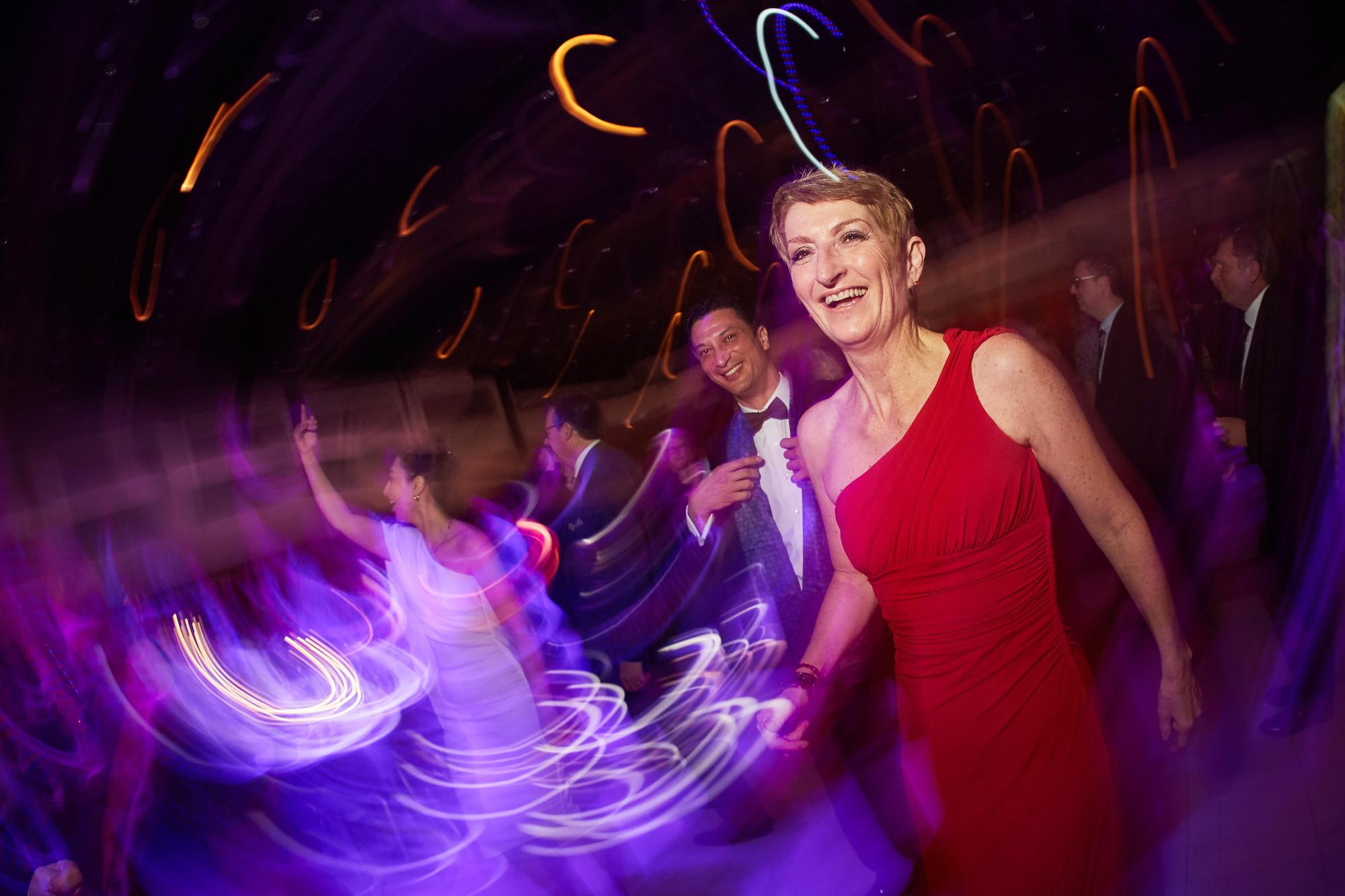 The emcee smiles as she is captured mid-laugh as the slow motion captures the party atmosphere.