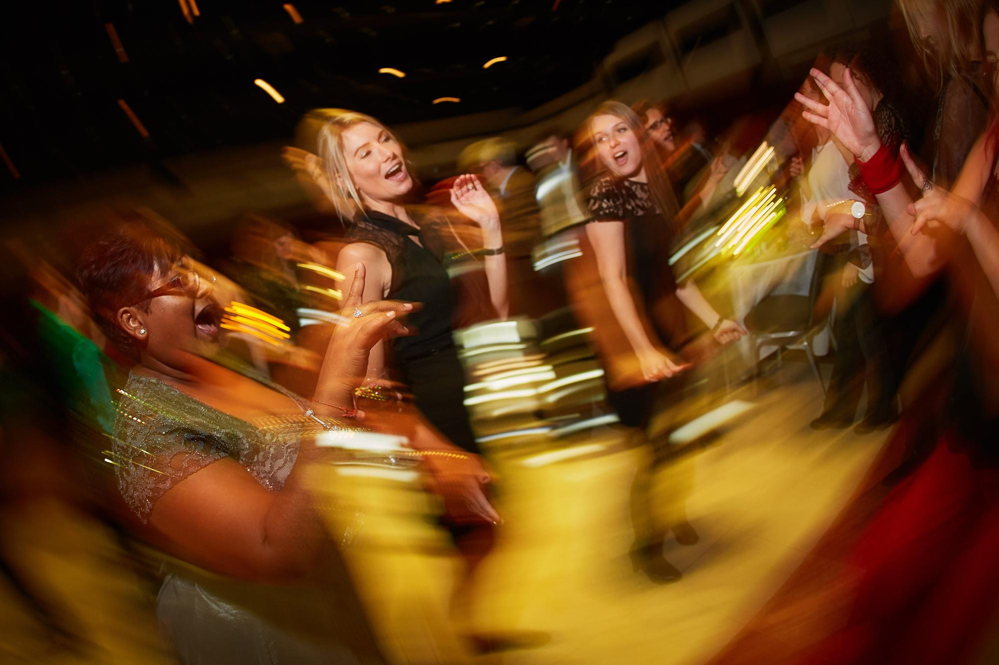 Slow-motion blur freezes the happy dancers atop the dance floor.