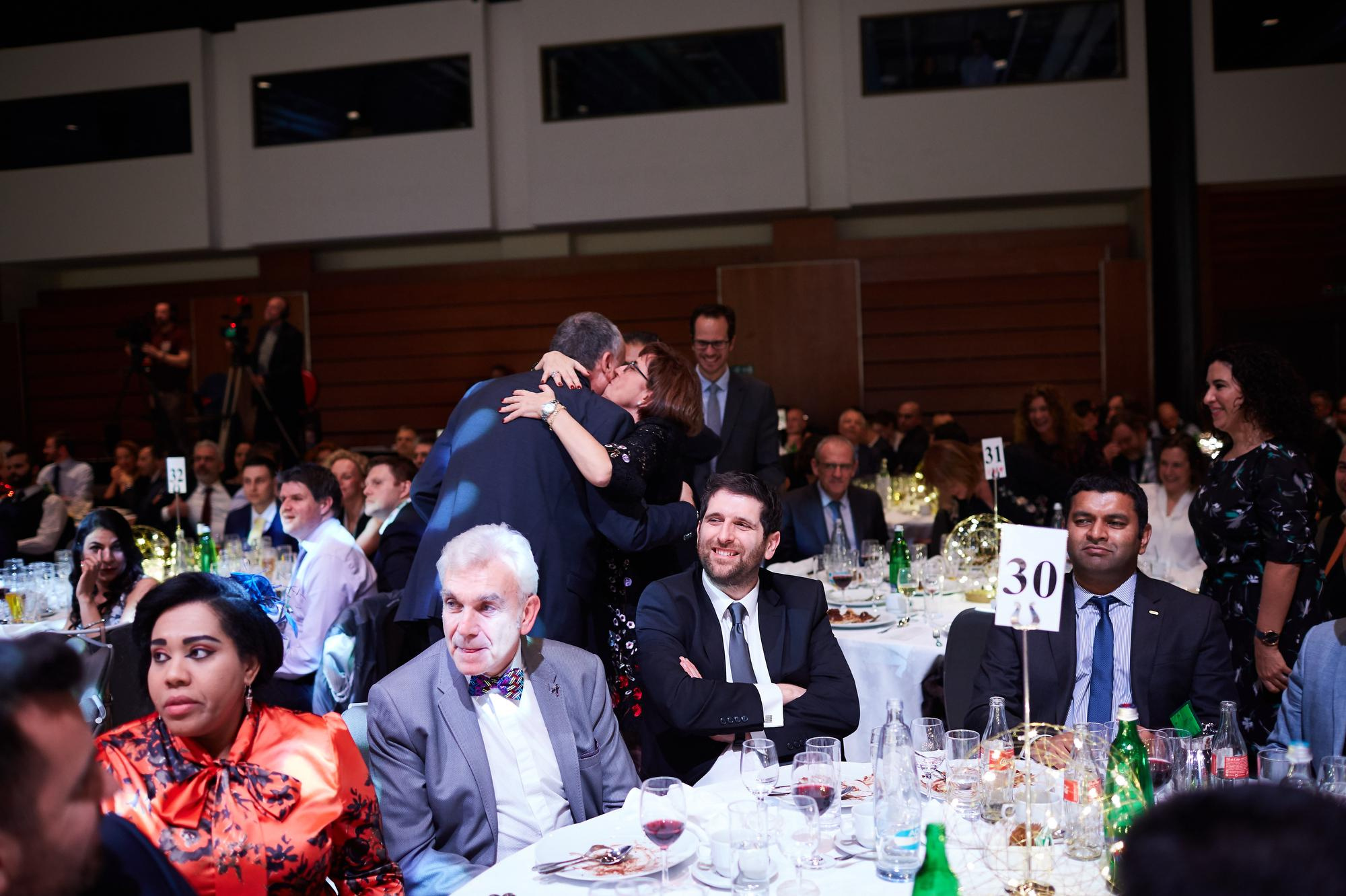 A Bio-Rad attendee is hugged by a member of the crowd during the award-ceremony.