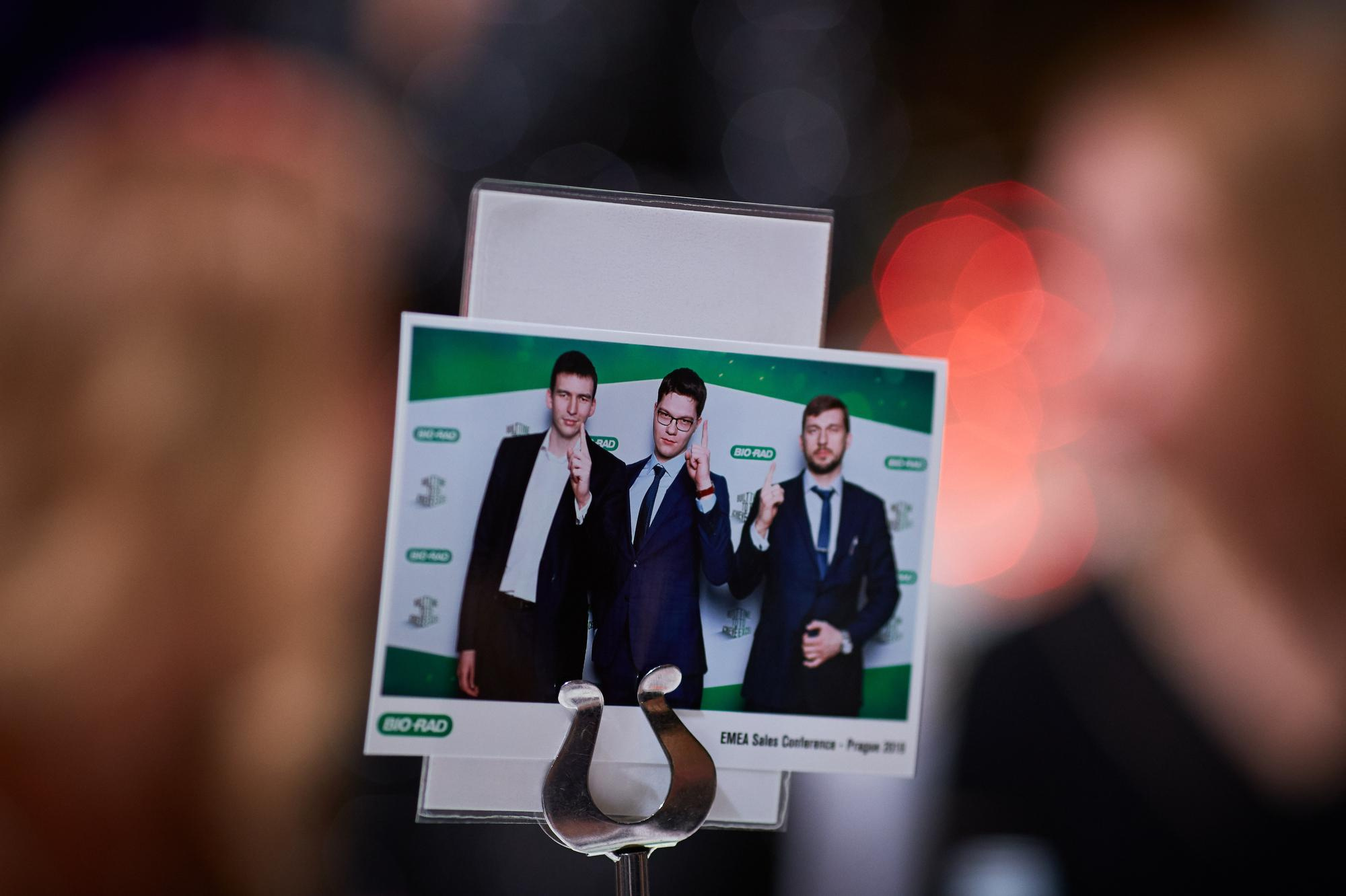 Employees receive gift photos from a photo booth.