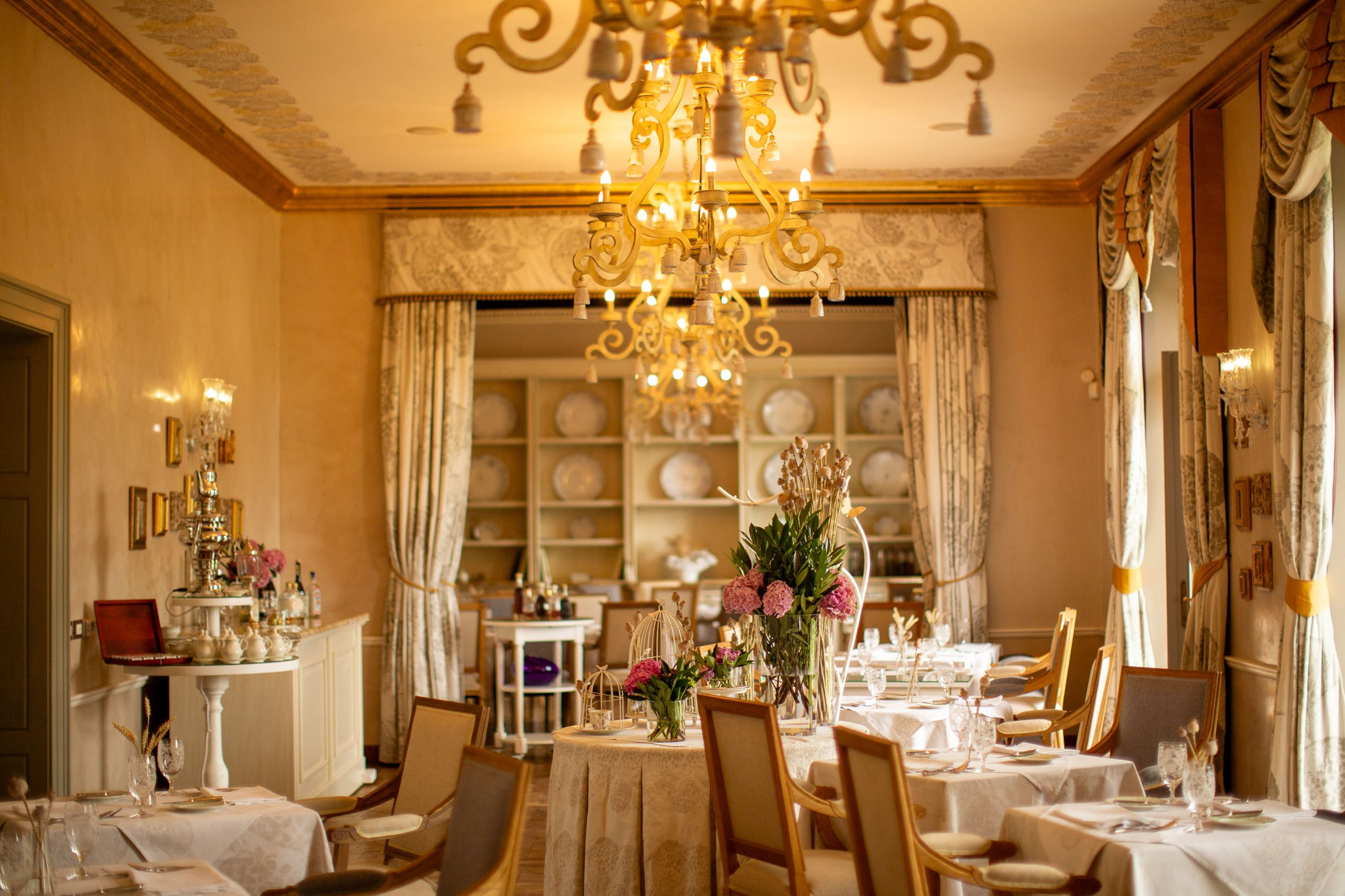 Wide-angle view of the elegant, historic chateau's main dining room, showcasing its stylish decor.