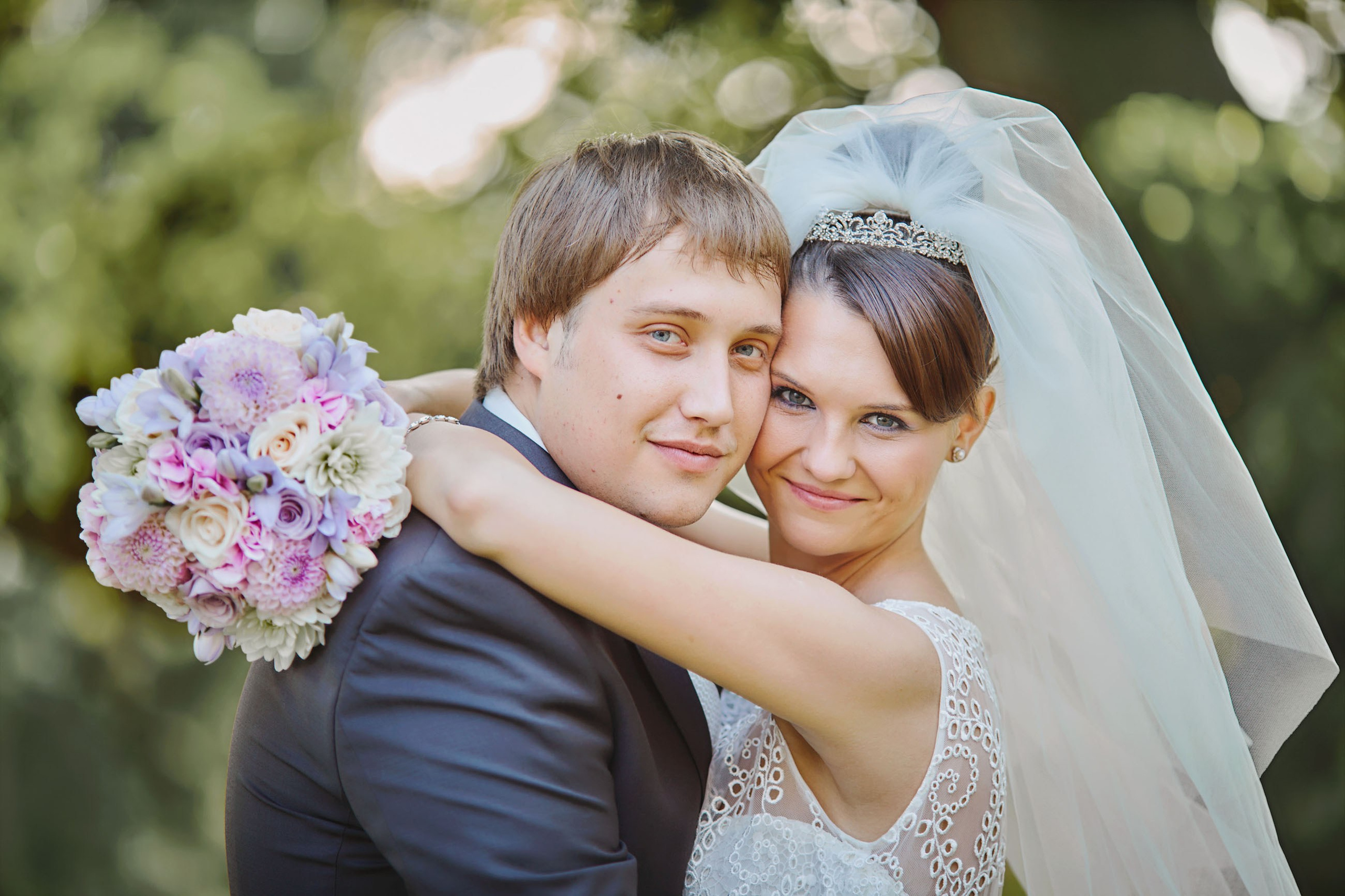 The smiling newlyweds embrace each other tightly during their short tour of the chateau grounds on their wedding day.